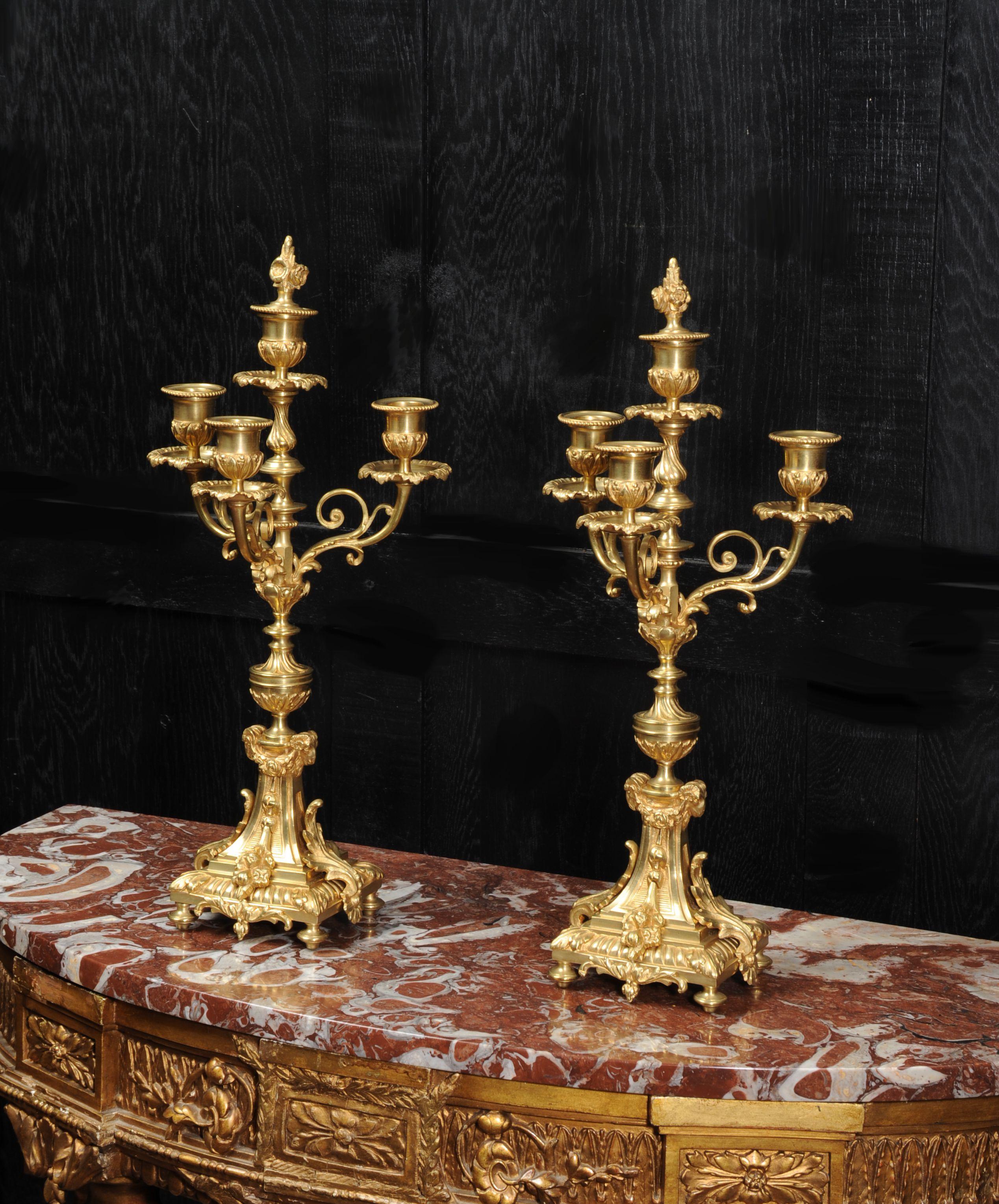 A superb pair of gilt bronze candelabra. They are French and date from circa 1880. Candelabra have three delicate acanthus arms and are complete with original snuffers that are stored in the central nozzle.

Dimensions of candelabra (with snuffers