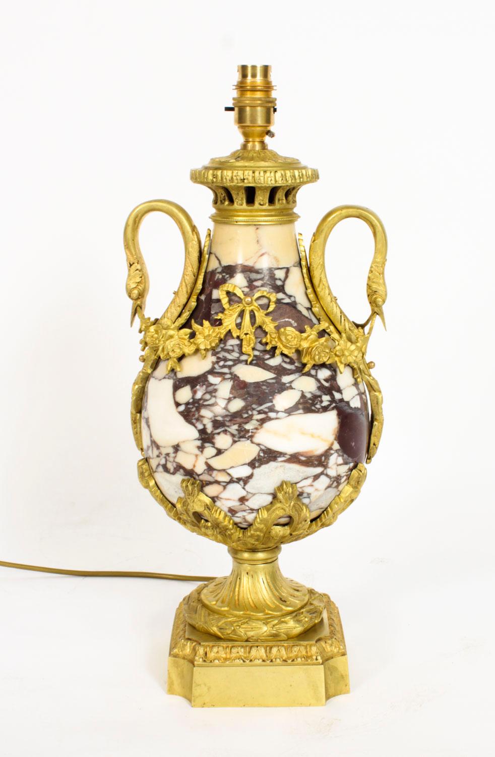 A beautiful French Louis XVI revival ormolu mounted marble table lamp, Circa 1860 in date.
 
This beautiful ormolu mounted boldly veined breche violette mable table lamp is decorated with superb ormolu swan handles and rococo decoration, is of