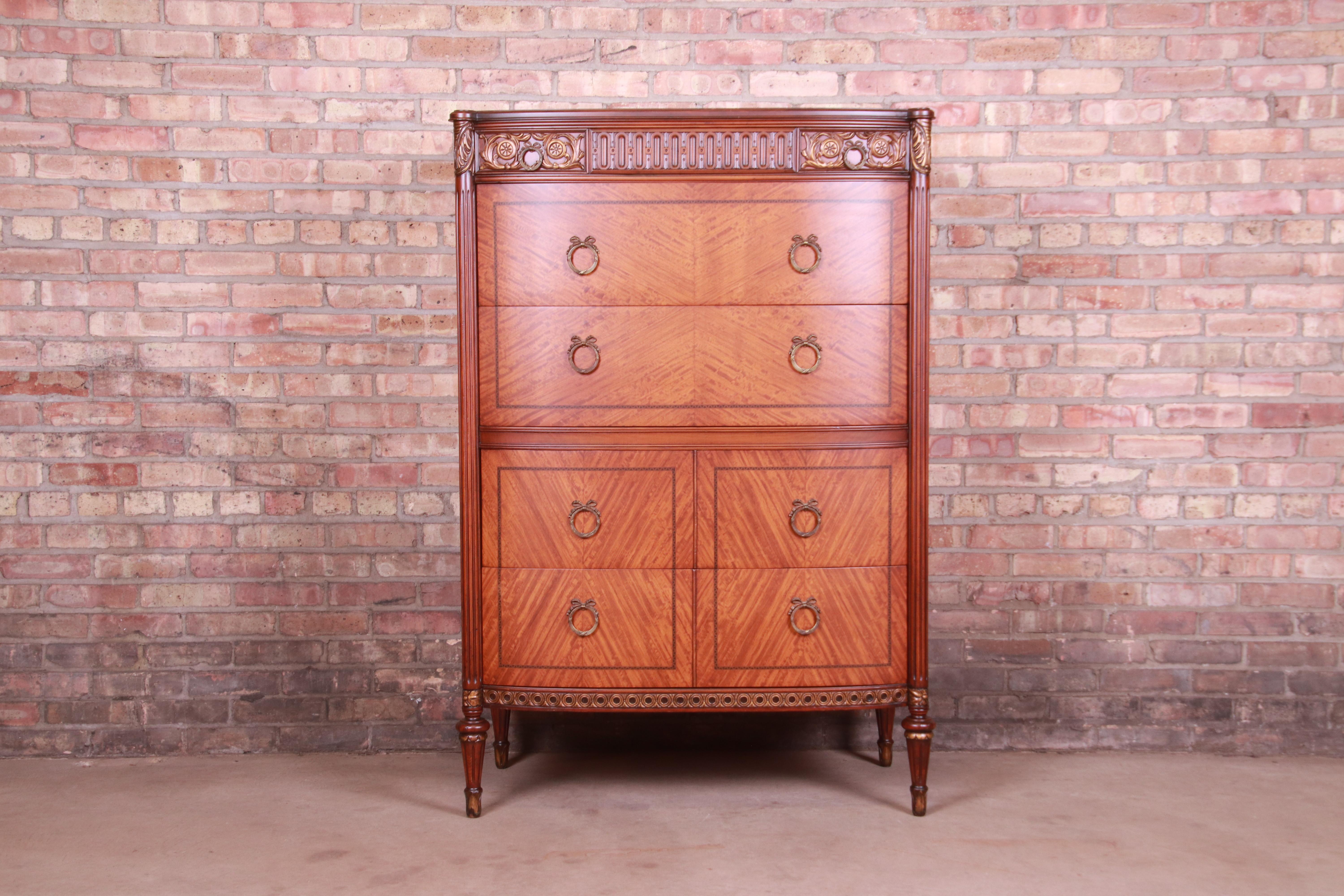 A gorgeous antique French Louis XVI style chest of drawers

By Saginaw Furniture

USA, Circa 1920s

Inlaid satinwood and mahogany, with original brass hardware.

Measures: 38.5