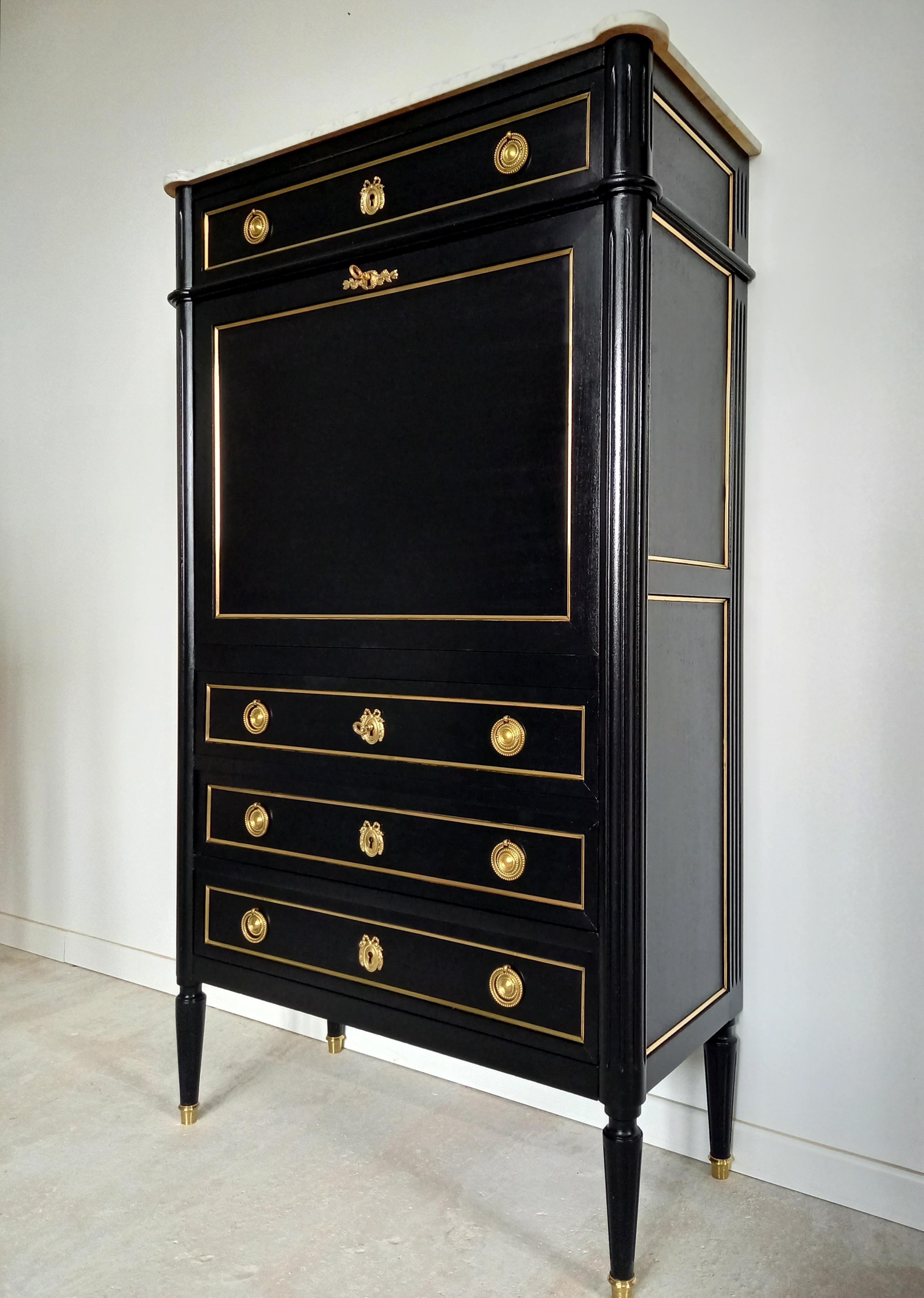 Antique French Louis XVI mahogany secretary chest of drawers topped with a white Carrara marble, fluted legs finished with golden bronze clogs and thorough dressed in bronze and brass details.
Marble and wooden structures are in excellent