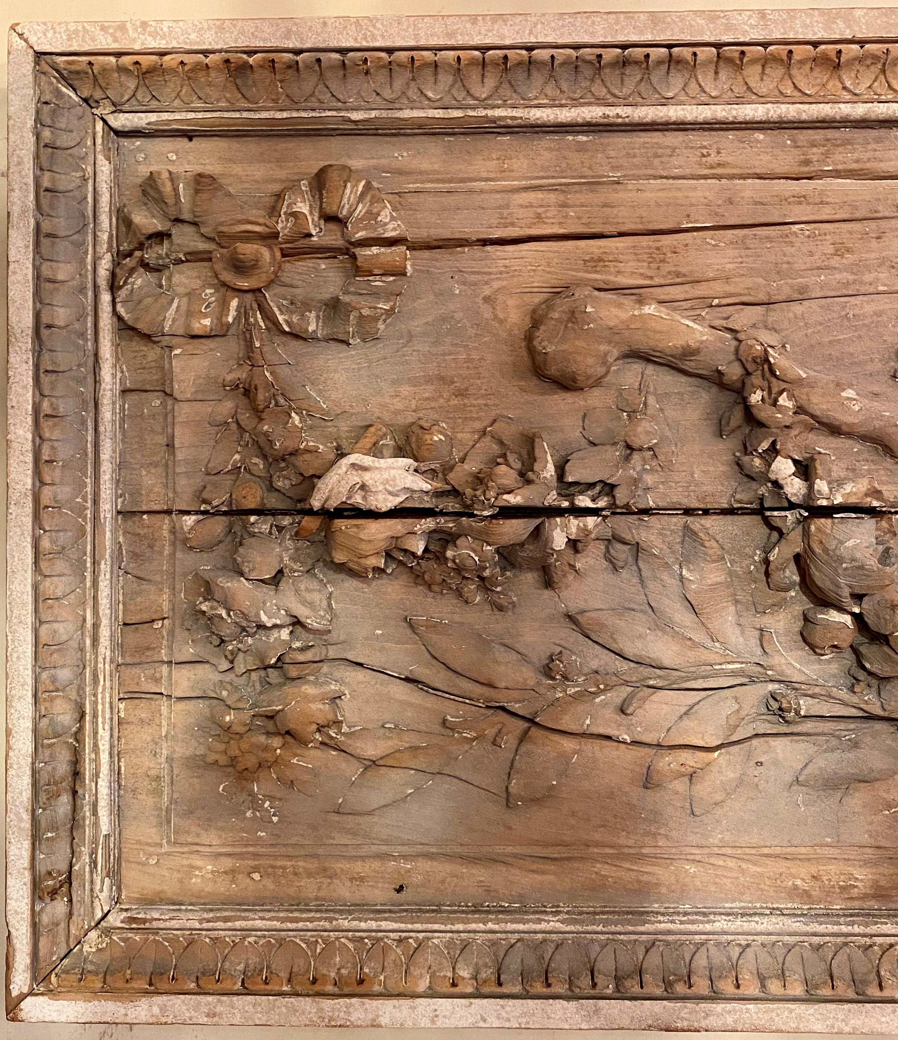 Finely carved antique French Louis XVI style 19th century ribbon and floral wooden wall plaque with floral swags, horns, and staffs.
This panel has a near match to it that is also available per Reference LU861922020232. Each is sold individually.