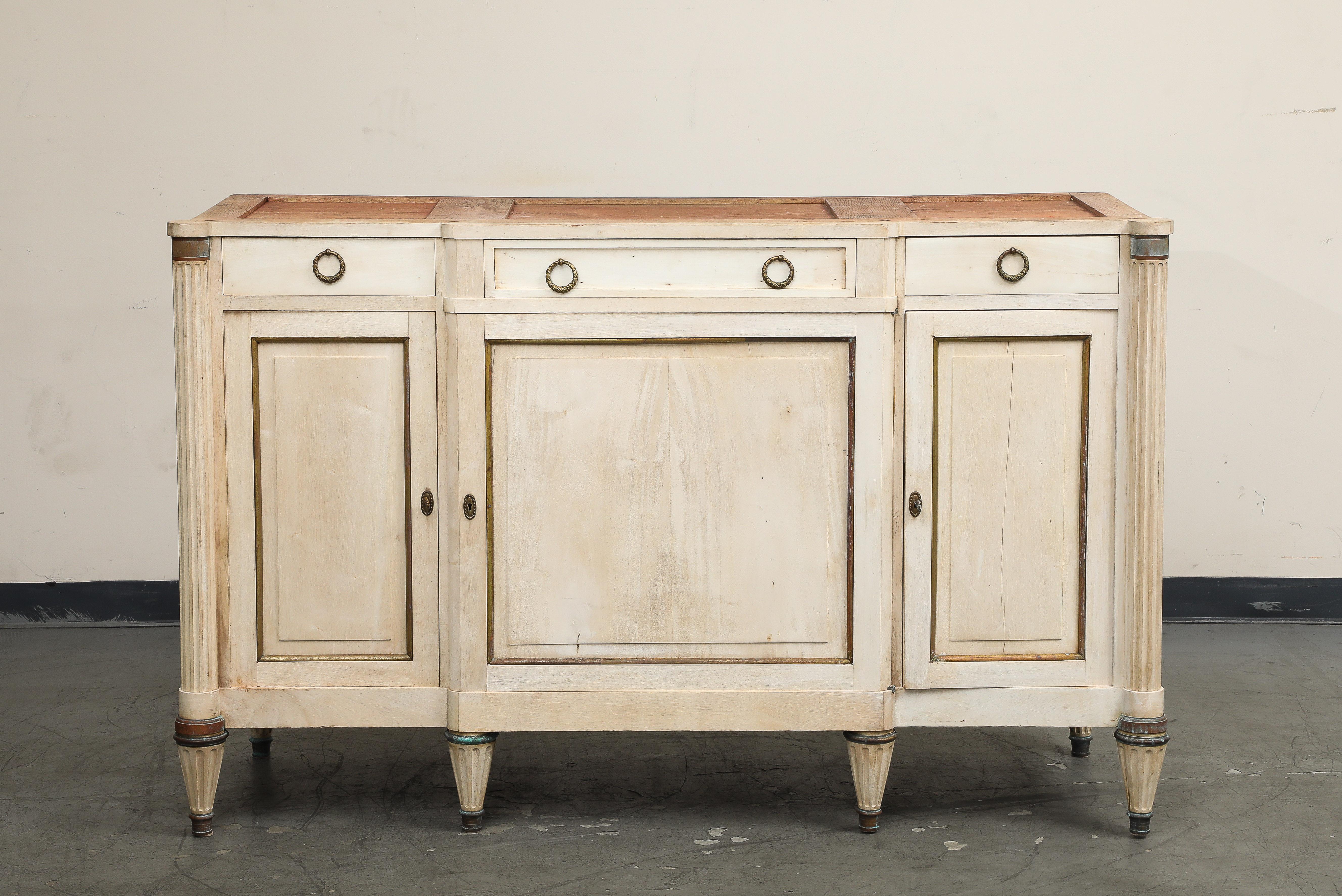 Antique French Louis XVI style enfilade from Provence, circa 1920s. Handcrafted of solid cherry with a bleached finish, this handsome French buffet provides excellent storage and a great surface for serving and display. It features a rectangular