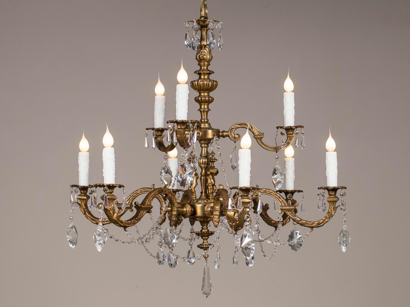 An antique French Louis XVI style bronze doré crystal chandelier from France, circa 1890. The lustrous finish of the gilded bronze provides a great background for the brilliance of the cut crystal drops and crystal swags dressing this French