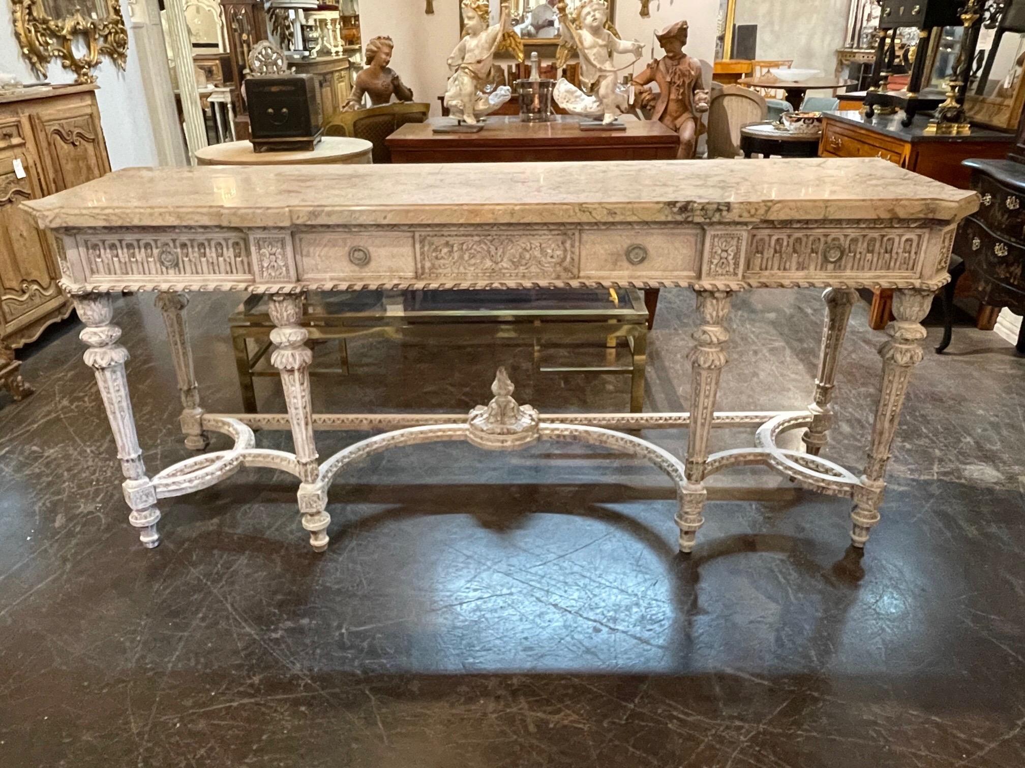Superb antique French Louis XVI style carved and painted console table. This piece is expertly carved and has a beautiful white washed patina. Lovely marble top as well. Gorgeous!!