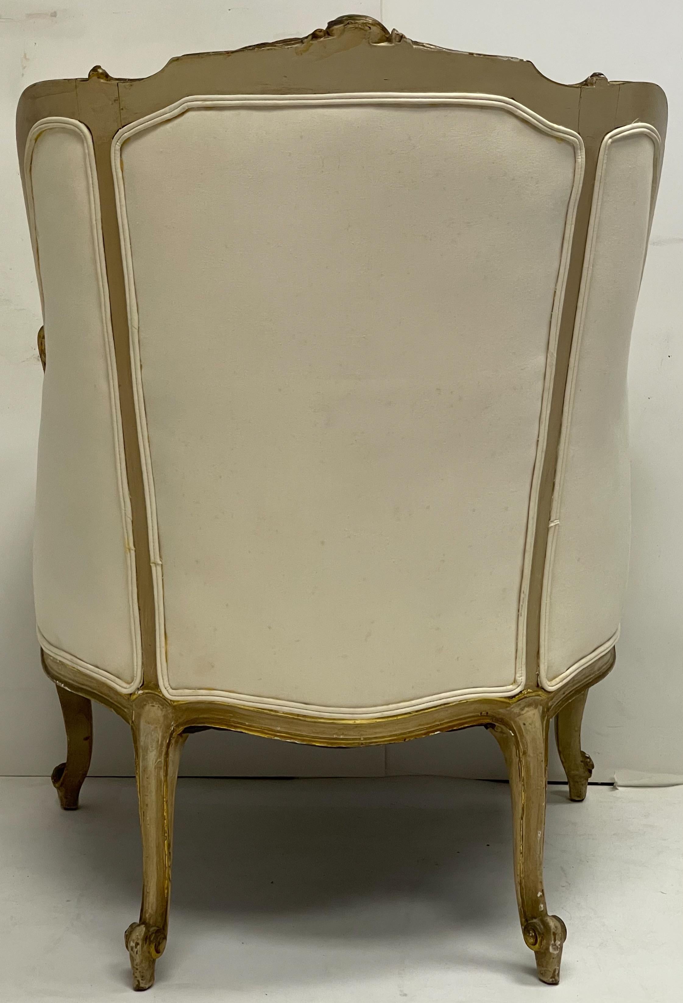 This is an antique French Louis XVI style bergere chair. The frame is both carved giltwood and paint. The upholstery is vintage and appears to be a cotton canvas type of fabric. The condition overall is strong. Arm;21”.