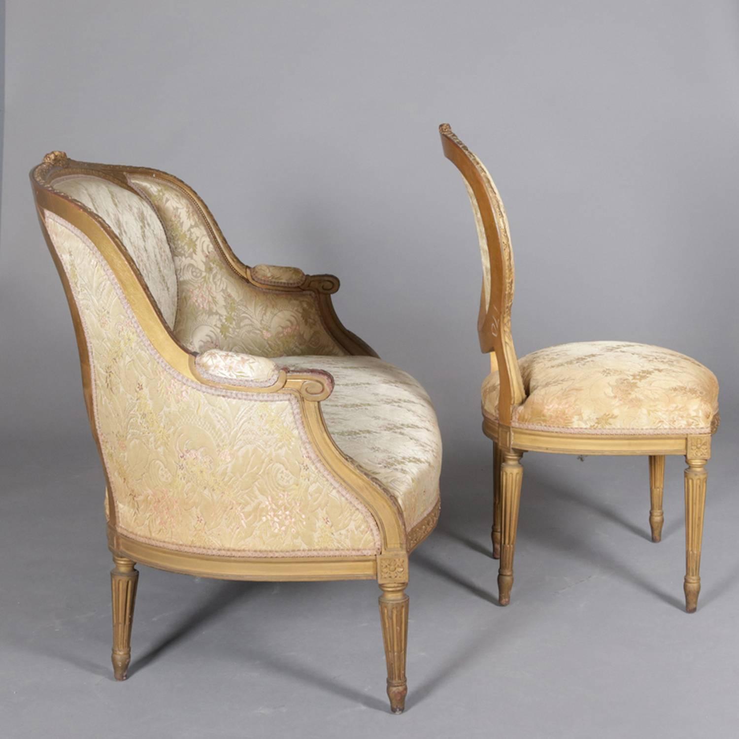 Two-piece French Louis XVI style parlor set features carved giltwood frame with scroll form arms and seated on tapered and reeded legs, upholstered seats and backs, set includes settee and side chair, circa 1890

Measures - settee: 38.5