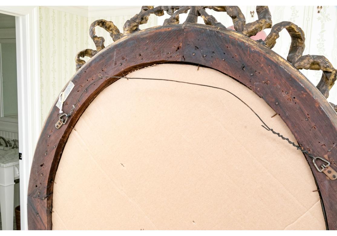 Antique French Louis XVI Style Carved Oval Gesso & Giltwood Mirror In Fair Condition For Sale In Bridgeport, CT