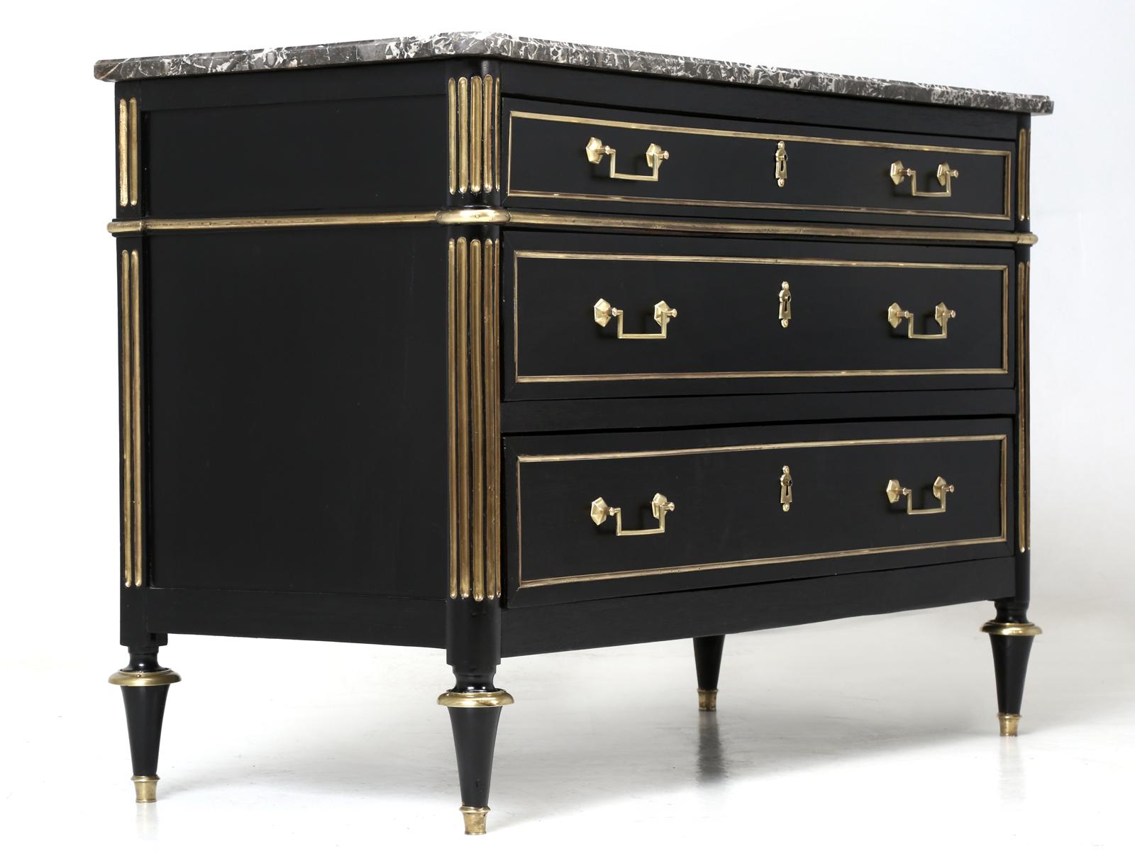 Antique French ebonized Louis XVI style commode, with a spectacular looking marble top. Our old plank in-house restoration department completely stripped this antique French Louis XVI style commode to the bare wood and removed all the brass trim