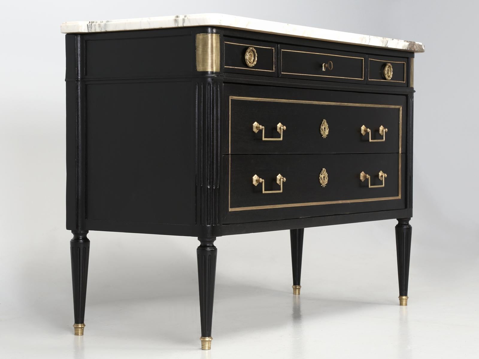 Antique French Louis XVI Style Commode that was hand-stripped in our Old Plank workshop and done is a beautiful ebonized finish, that almost looks black. What really makes this antique Louis XVI style black commode, or chest Stand of drawers Stand