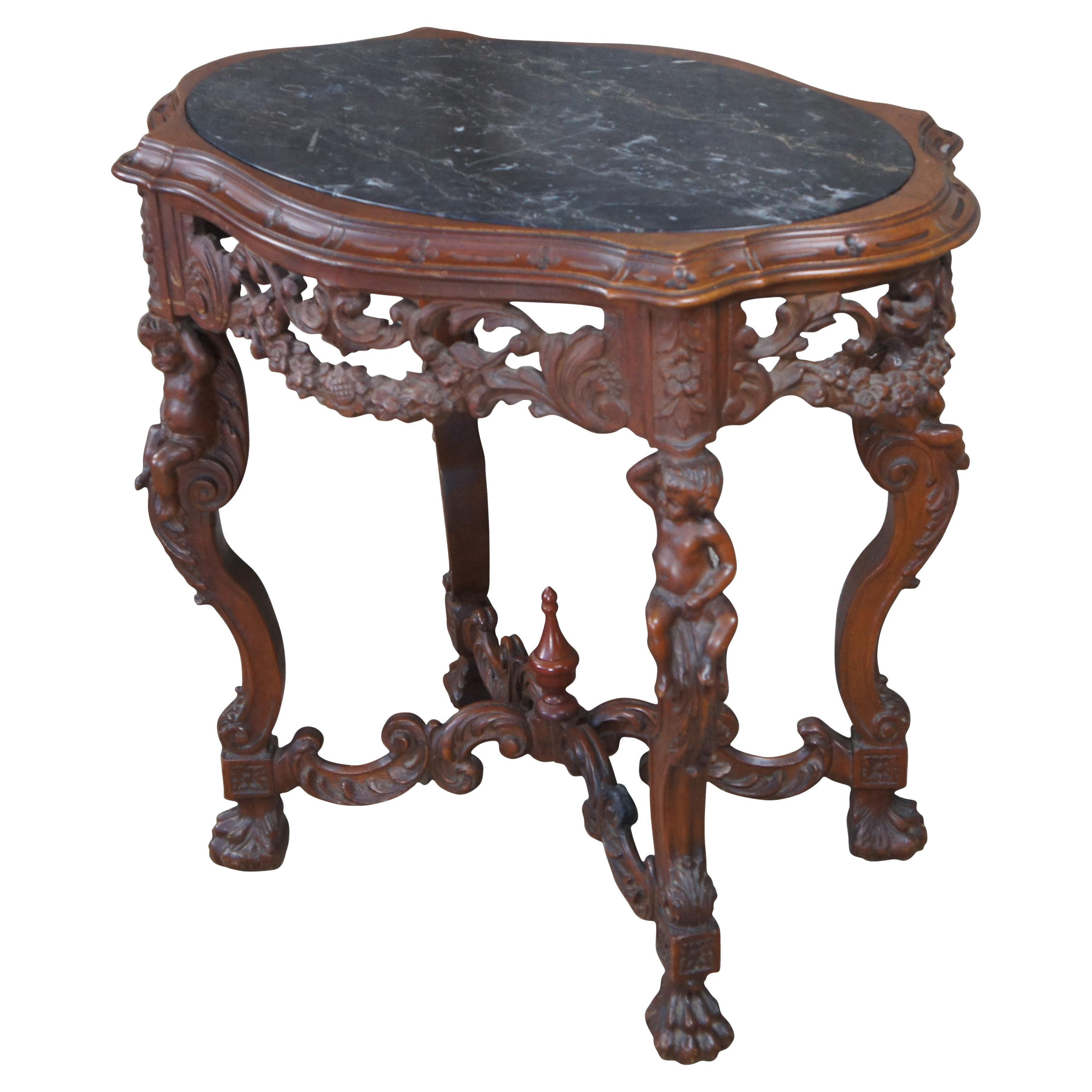 An exquisite Late Victorain parlor era parlor table.  Drawing inspiration from Renaissance Revival and Louis XVI styling.  Made from walnut with an oval marble inset turtle top over a pierced scrolling foliate and swag frieze.  The table is