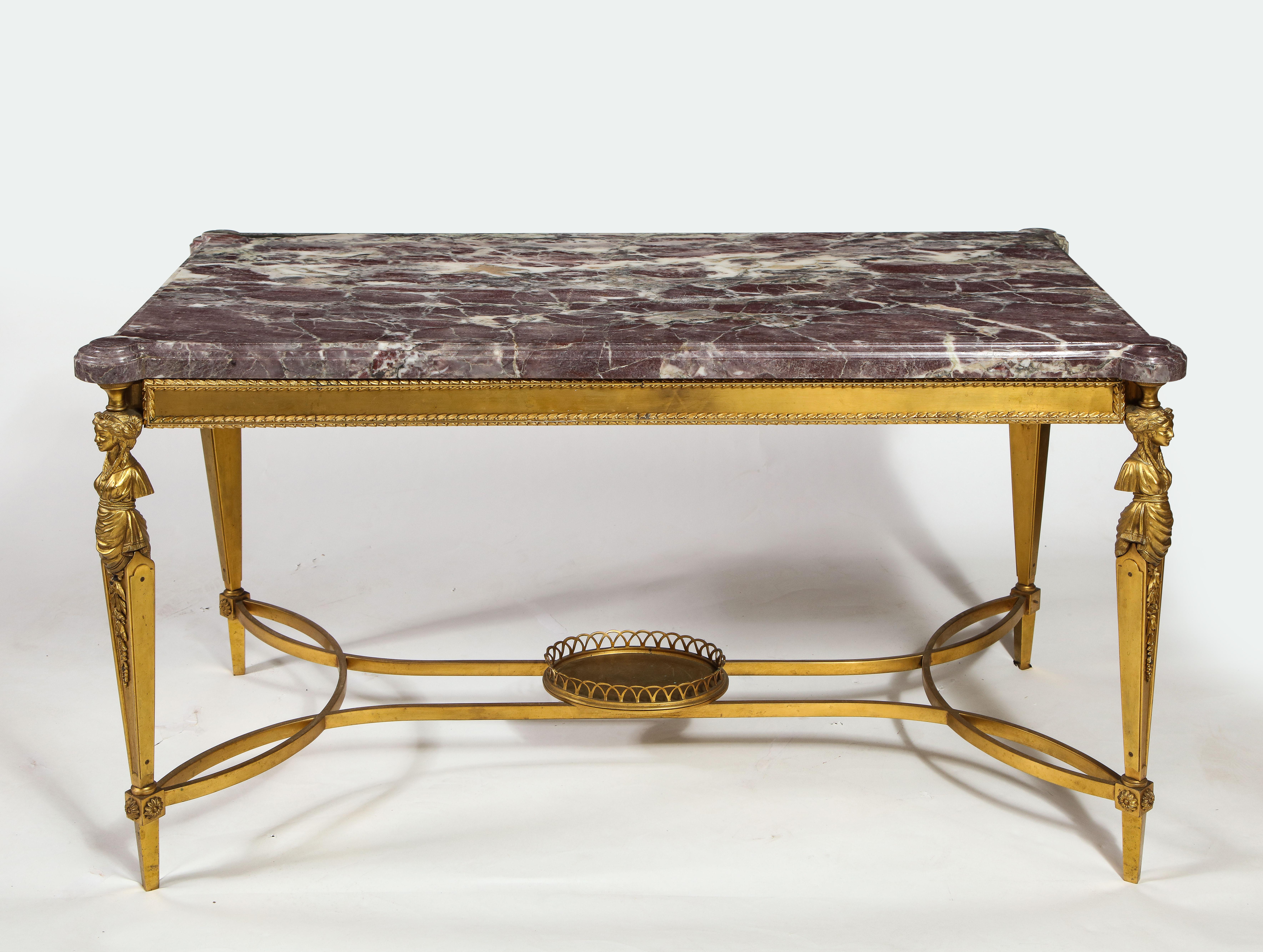 This exquisite Antique French figural rectangular form gilt bronze coffee table is designed in the Louis XVI style. This unusual table features a thick rectangular marble top in deep purple with white and gray veining, supported by a finely cast