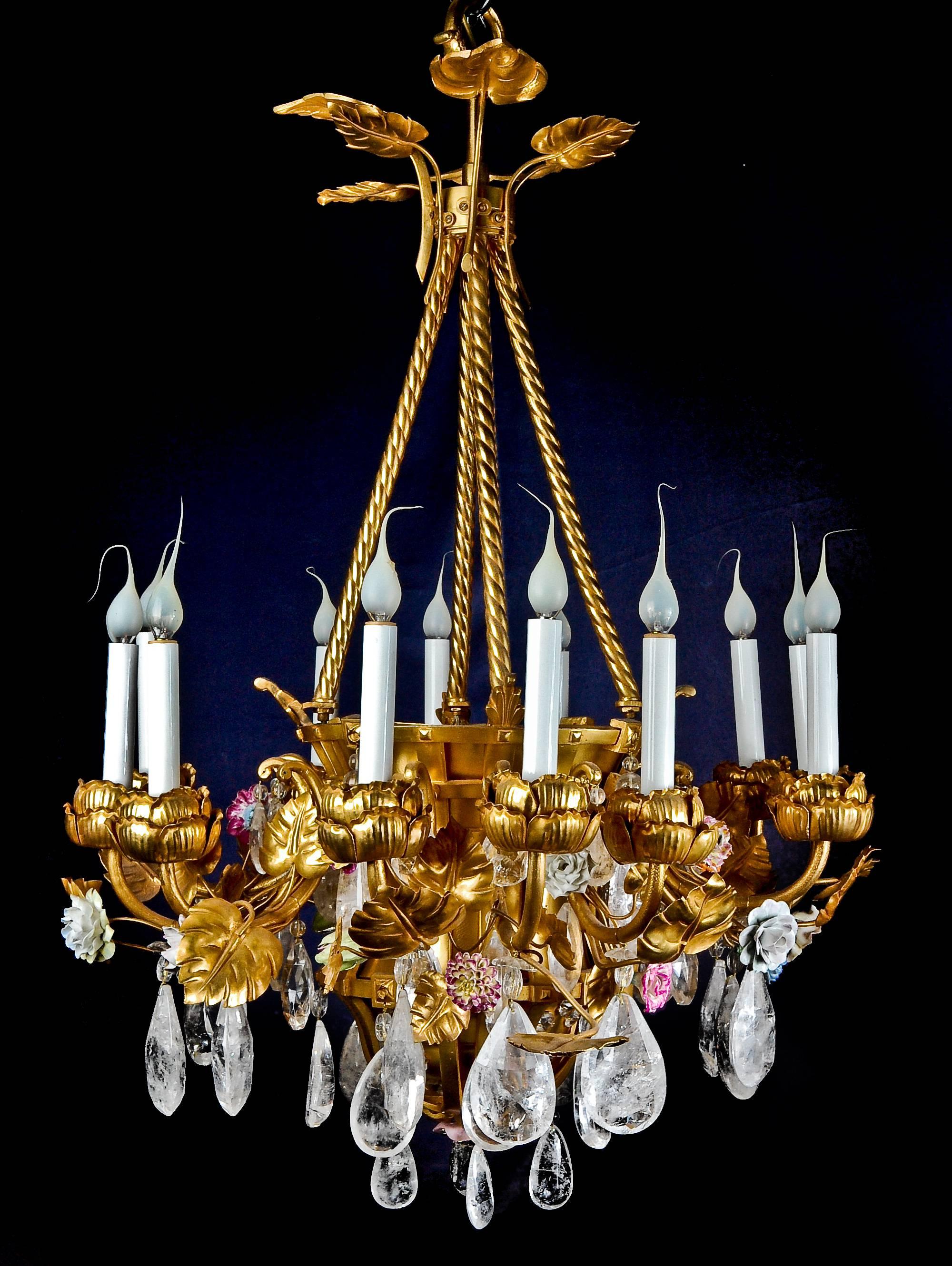 A unique antique French Louis XVI style gilt bronze, porcelain and rock crystal multi light basket form chandelier of superb craftsmanship. This unusual chandelier is embellished with gilt bronze flowers, polychromed porcelain flowers and further