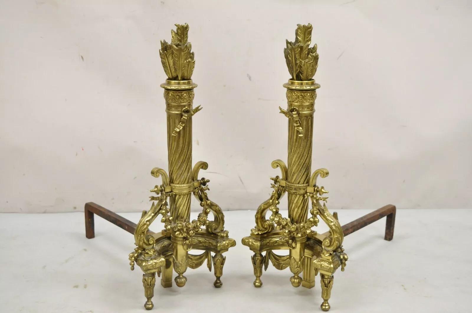 Andirons anciens en bronze doré de style Louis XVI, avec flèches et carquois - Paire. Cette pièce se caractérise par des formes hautes et majestueuses, un superbe moulage en bronze doré avec des draperies, des carquois et des flèches, ainsi qu'une