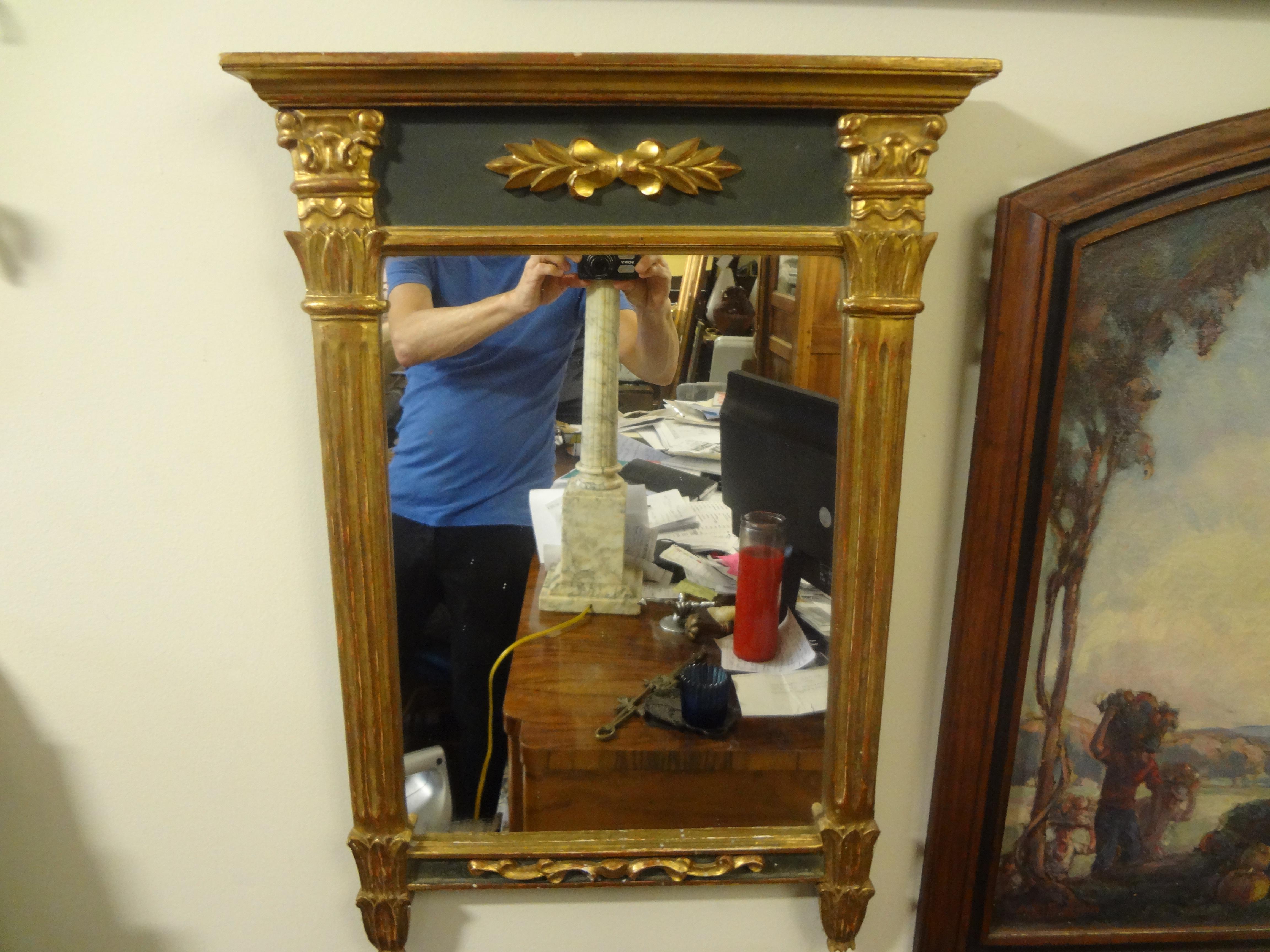 Antique French Louis XVI style giltwood mirror.
Charming French Louis XVI style painted and giltwood mirror. This lovely traditional French gilt wood mirror is flanked by columns on either side. Our French Louis XVI Neoclassical style mirror dates