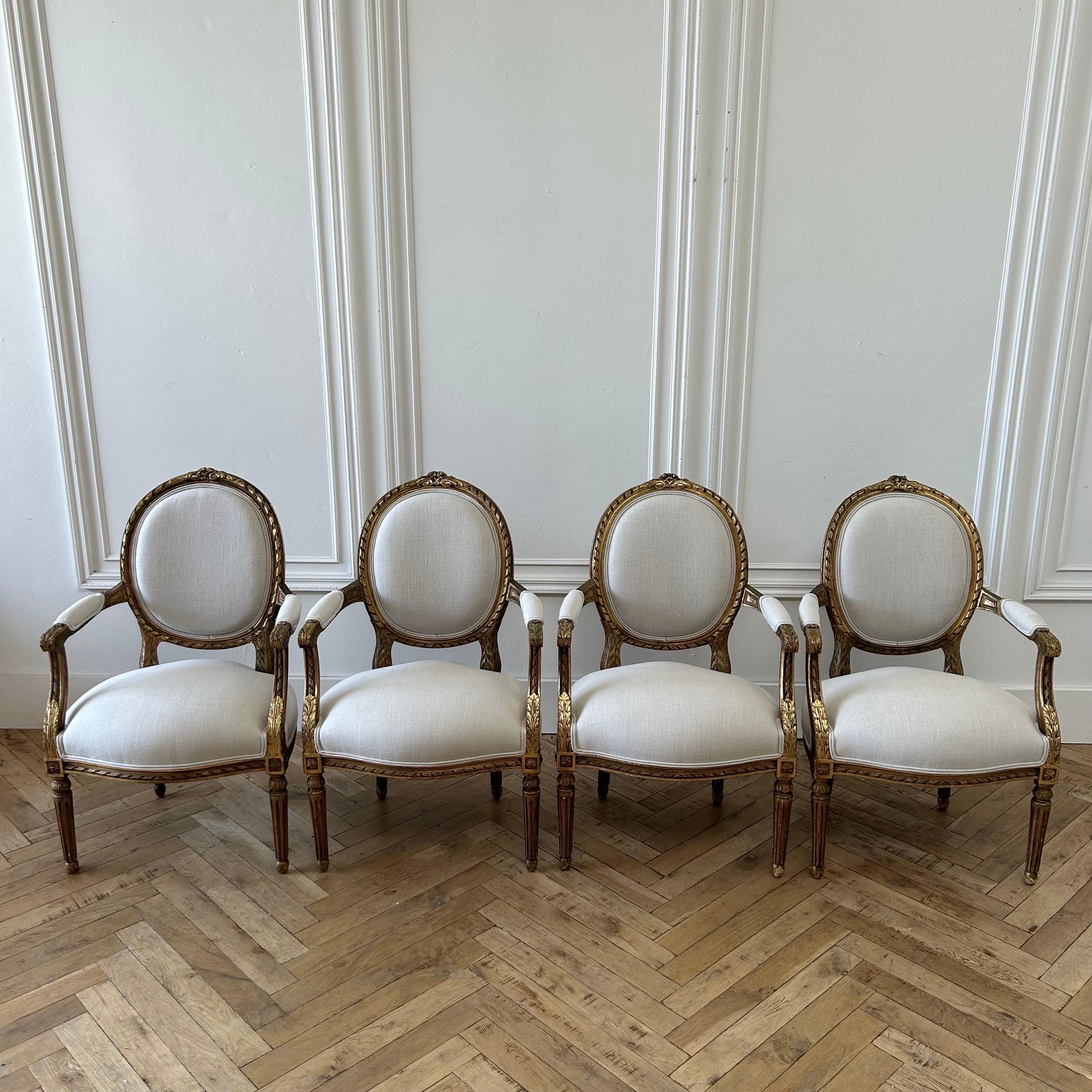 Antique French Louis XVI Style Gilt Wood Upholstered Linen Arm Chairs In Good Condition For Sale In Brea, CA