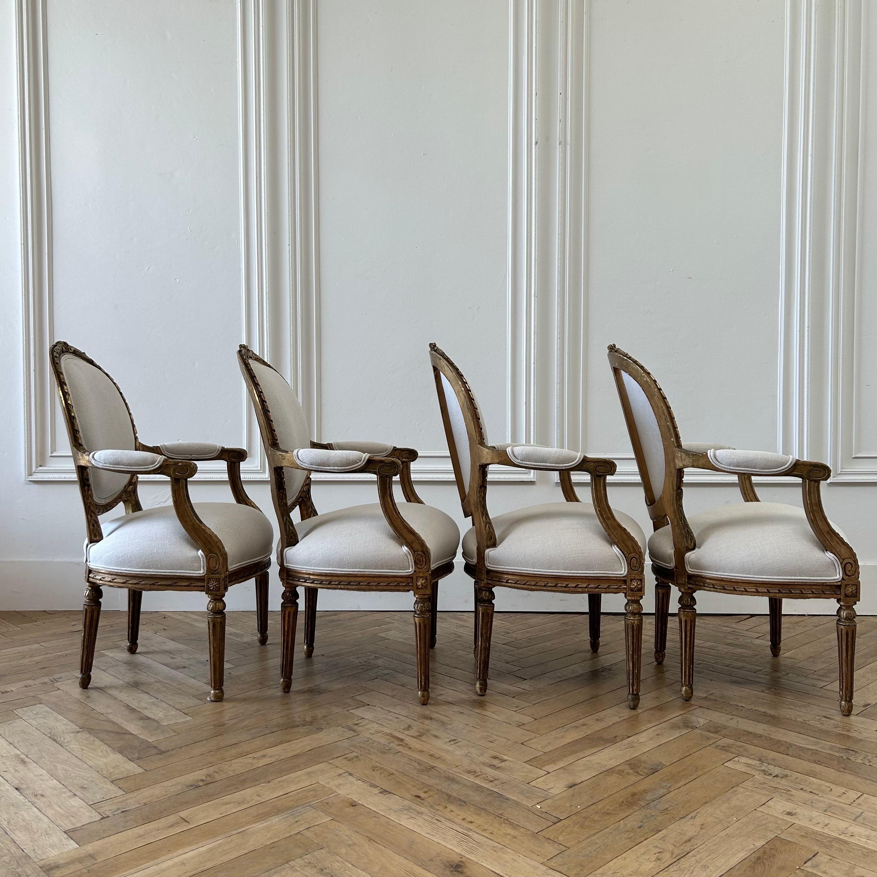 Antique French Louis XVI Style Gilt Wood Upholstered Linen Arm Chairs For Sale 1
