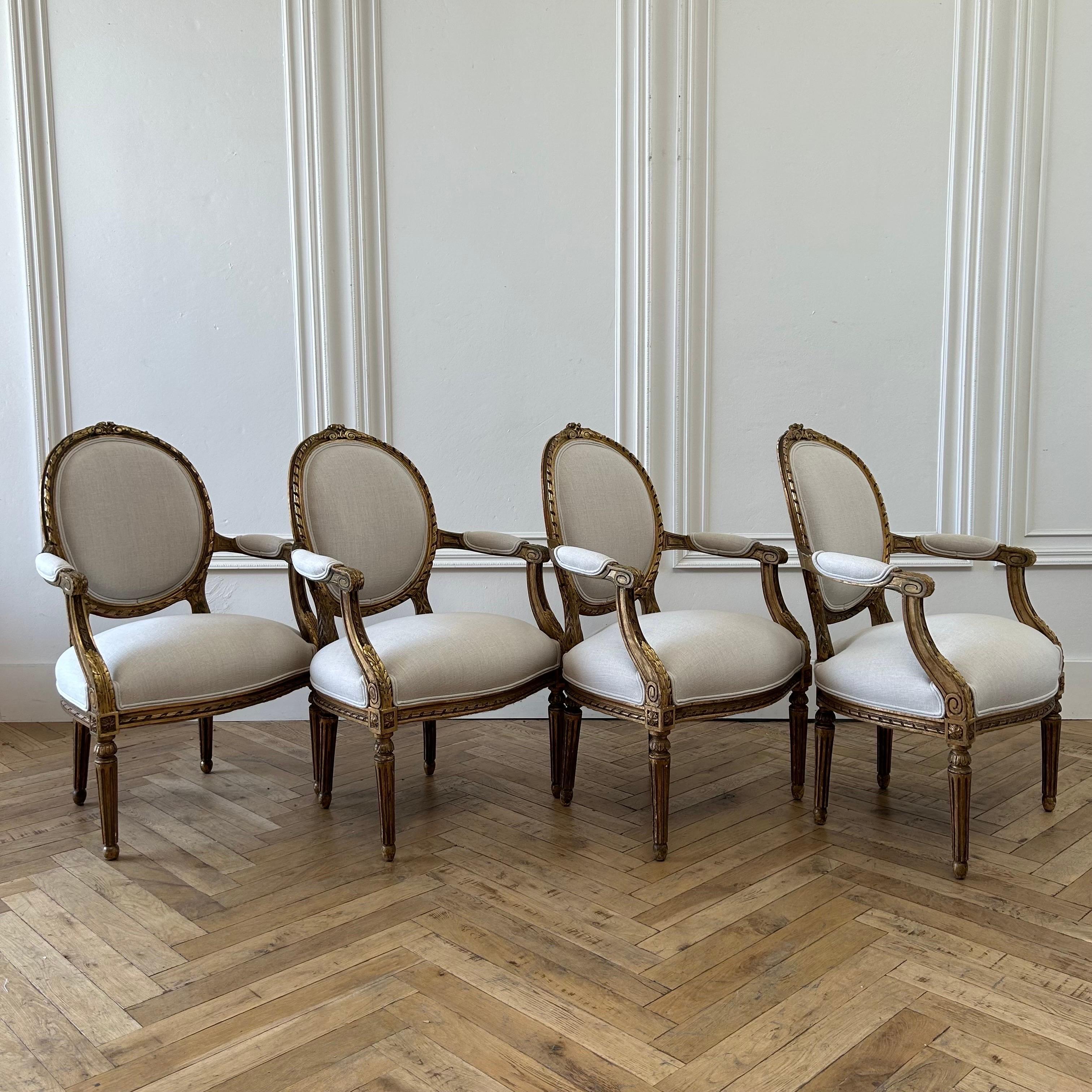 Antique French Louis XVI Style Gilt Wood Upholstered Linen Arm Chairs For Sale 2