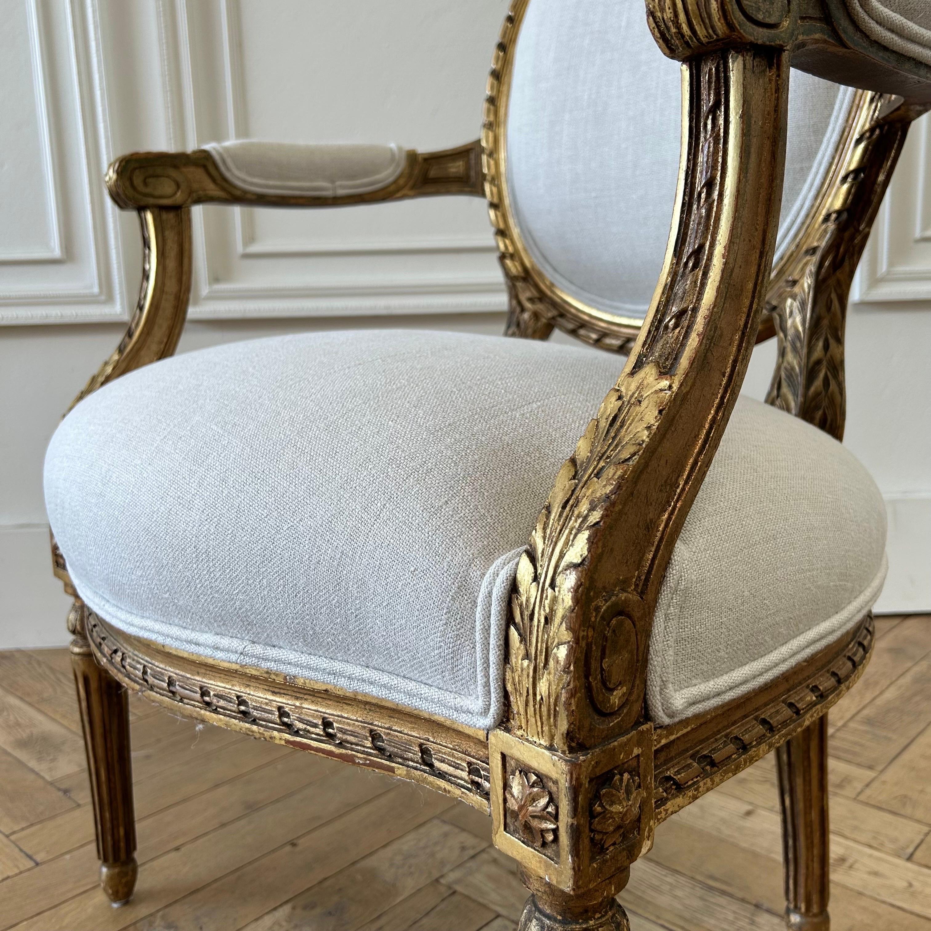 Antique French Louis XVI Style Gilt Wood Upholstered Linen Arm Chairs For Sale 4