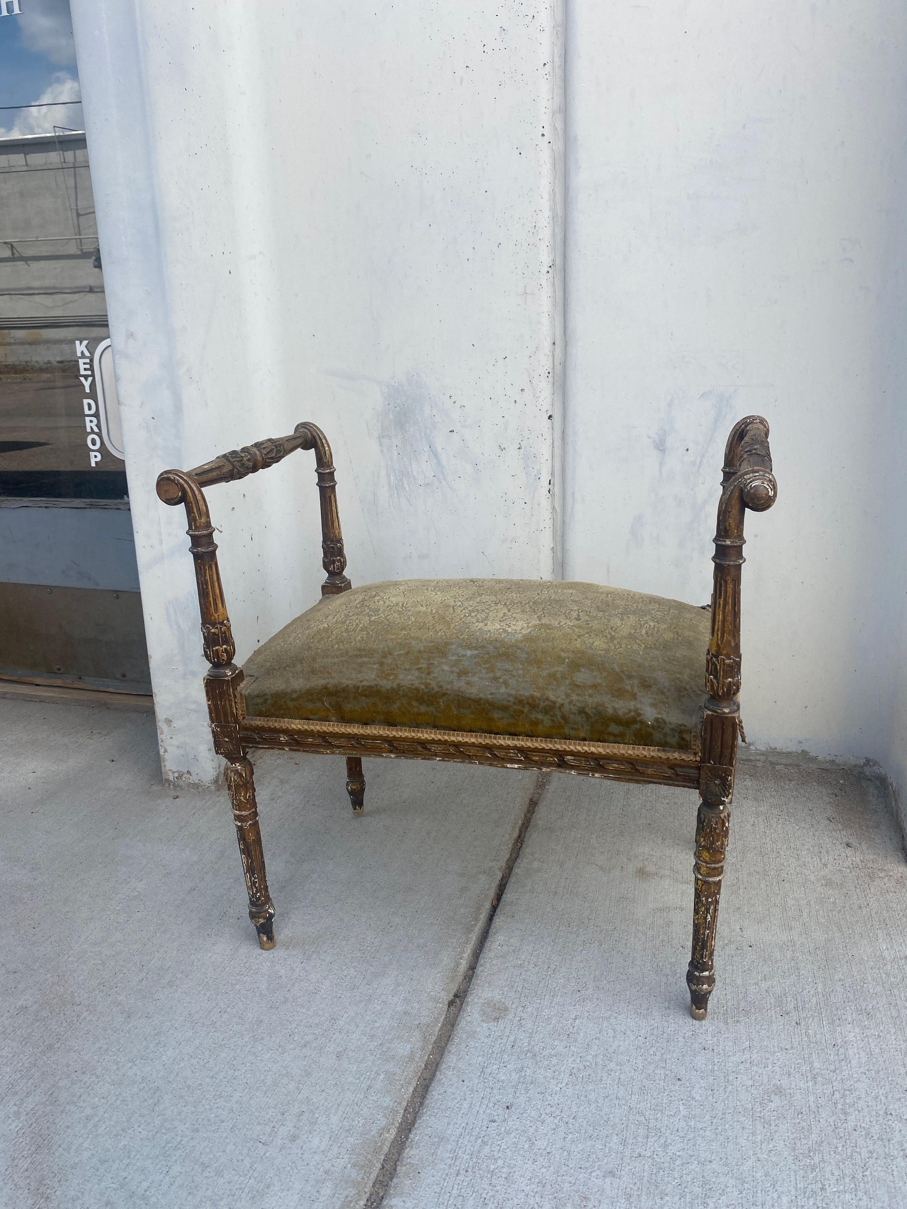 French Louis XVI style benches, late 19th/ early 20th c. Wood frame in a distressed finish, scrolled acanthus leaf carved arms, green mohair upholstered seat, rising on tapering fluted legs, mohair with significant loss to pile.

Dimensions: approx
