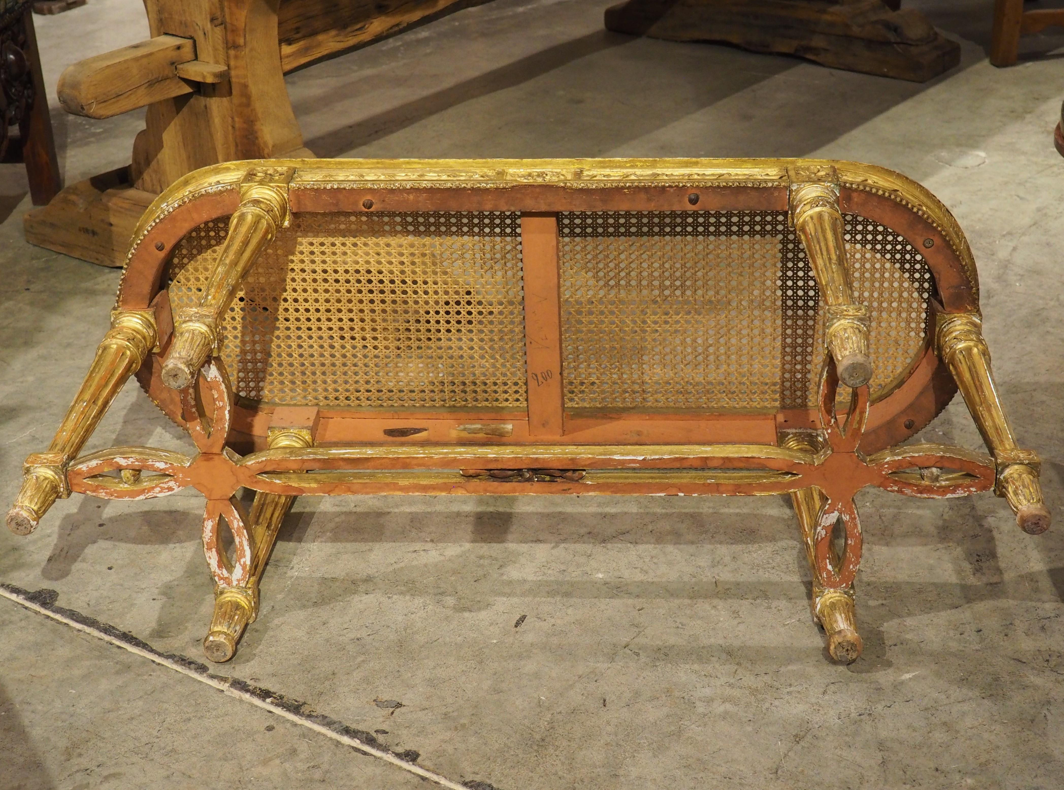 More information coming soon…

The Neoclassical motifs of this hand-carved giltwood bench are indicative of the stylings of Louis XVI.  This French bench, which dates to circa 1885, has an caned ovate seating surface that is topped by a French gray