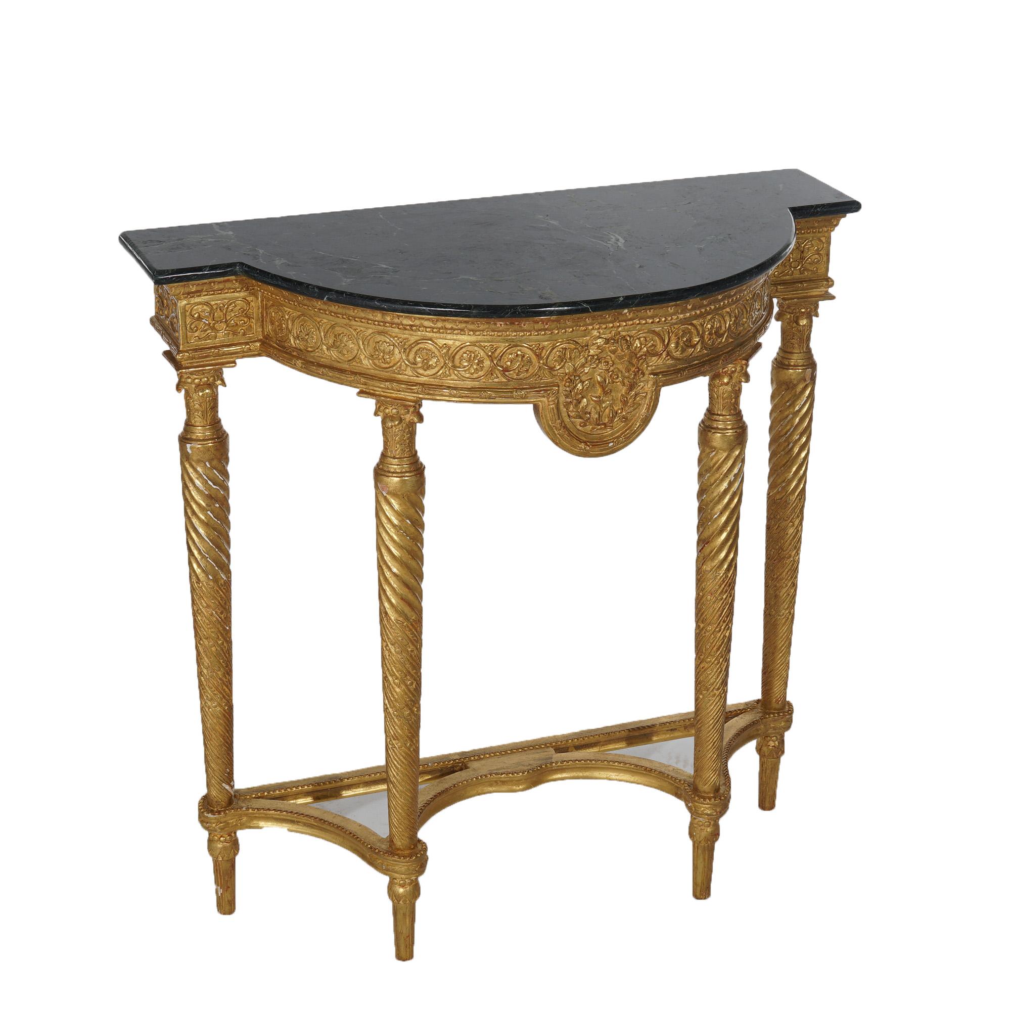 ***Ask About Reduced In-House Shipping Rates - Reliable Service & Fully Insured***
An antique French Louis XVI style hall table offers stylized demilune form with marble top over giltwood base having scroll and foliate elements, raised on tapered