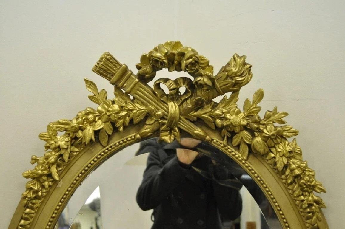 Unknown Antique French Louis XVI Style Gold Gilt Torch Flame Gesso Oval Wall Mirror For Sale