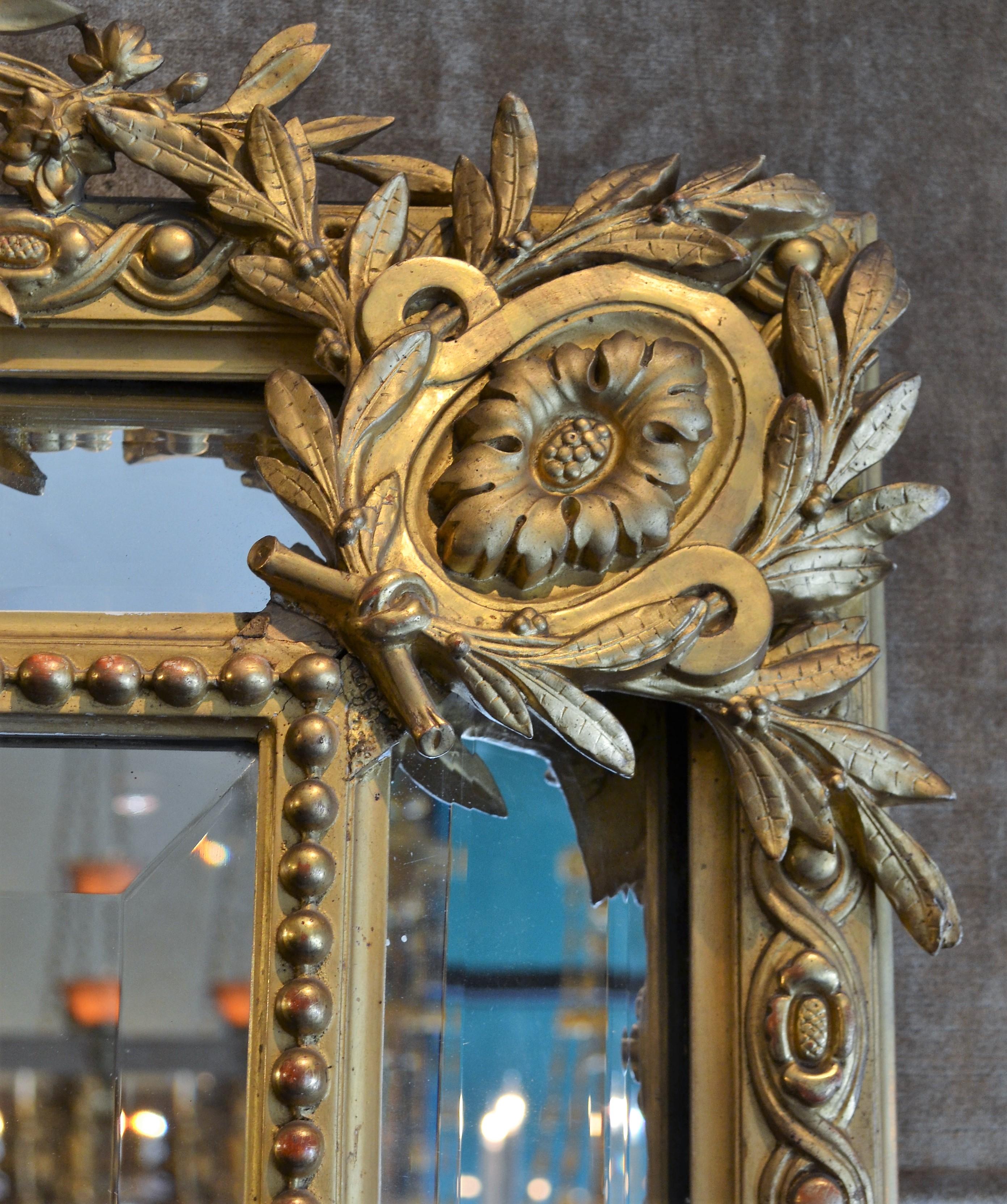 Antique French Louis XVI gold leaf beveled mirror.