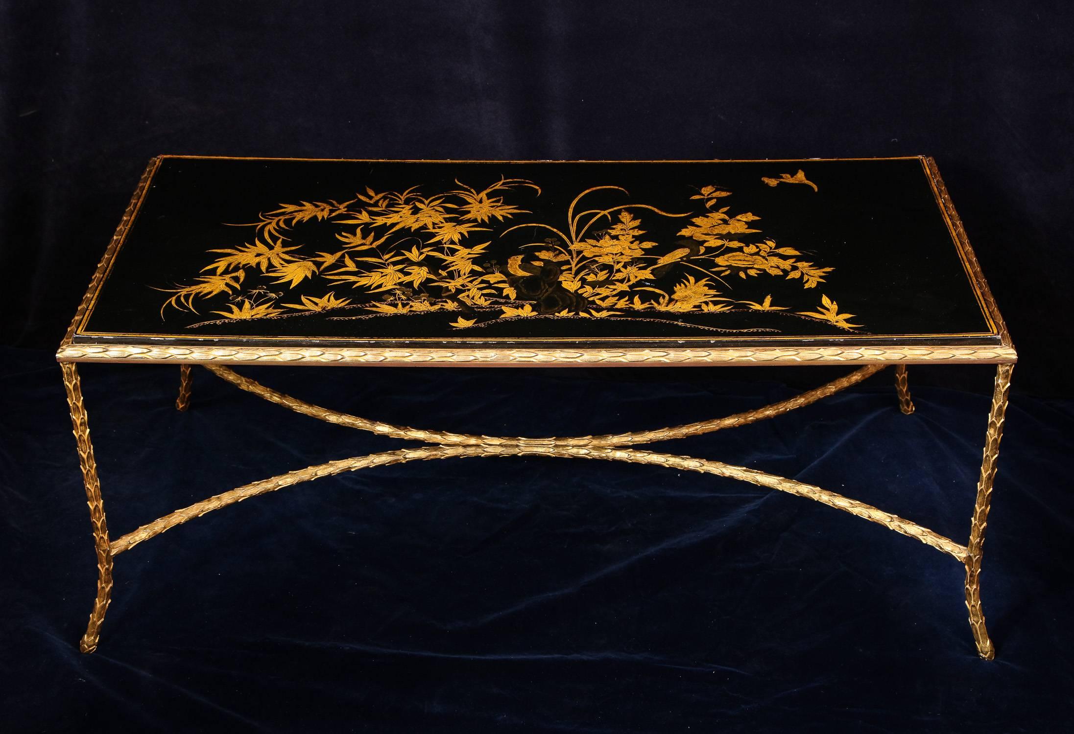 A unique antique French Louis XVI style rectangular black gilt decorated lacquered top gilt bronze coffee table of great detail hand-painted in gilt depicting birds and flowers attributed to Maison Bagues, Paris.