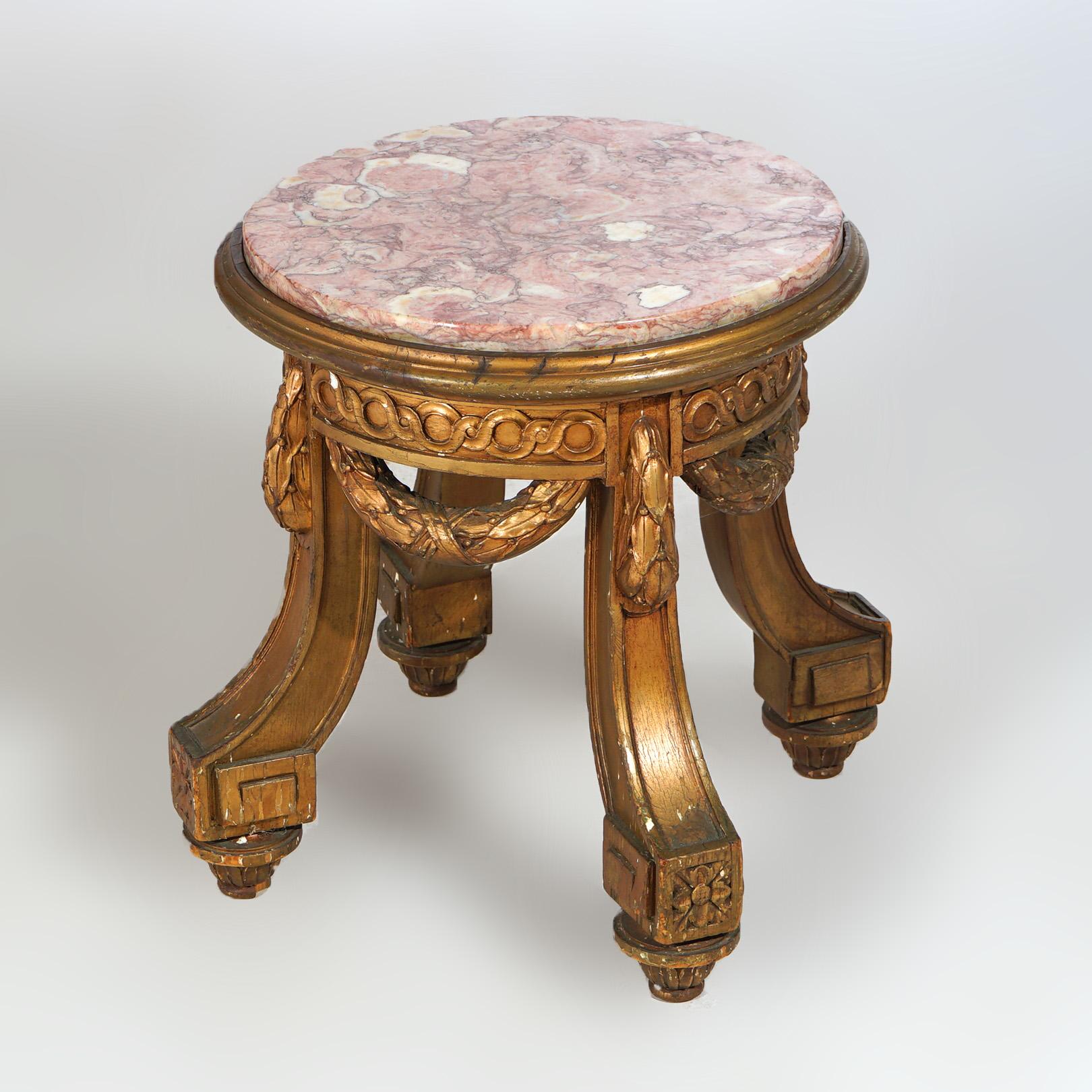 An antique French Louis XVI style low stand offers circular marble top over giltwood base having foliate swag and Greek Key decoration, c1820

Measures- 18''H x 20''W x 20''D