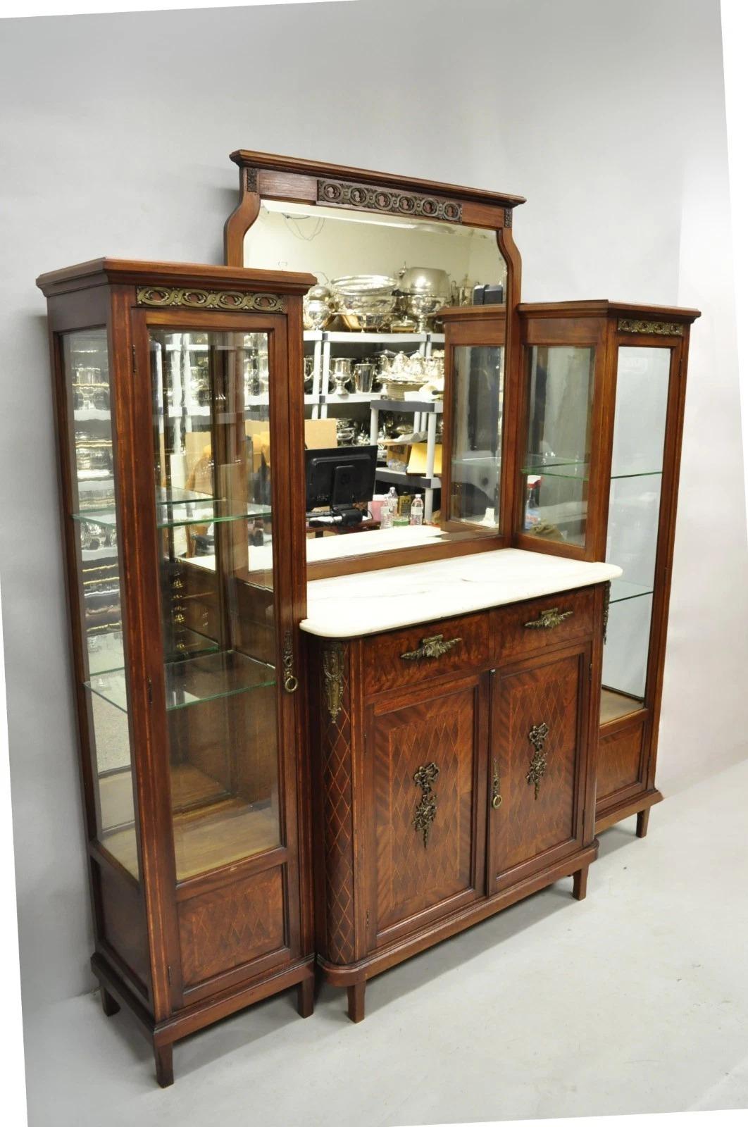 Please message us with your zip code to request a more reasonable domestic U.S. shipping quote.

Antique French Louis XVI Style Marquetry Inlay Sideboard Buffet Curio Cabinet by J. Wernier, Paris. Item features a central marble top, beveled glass