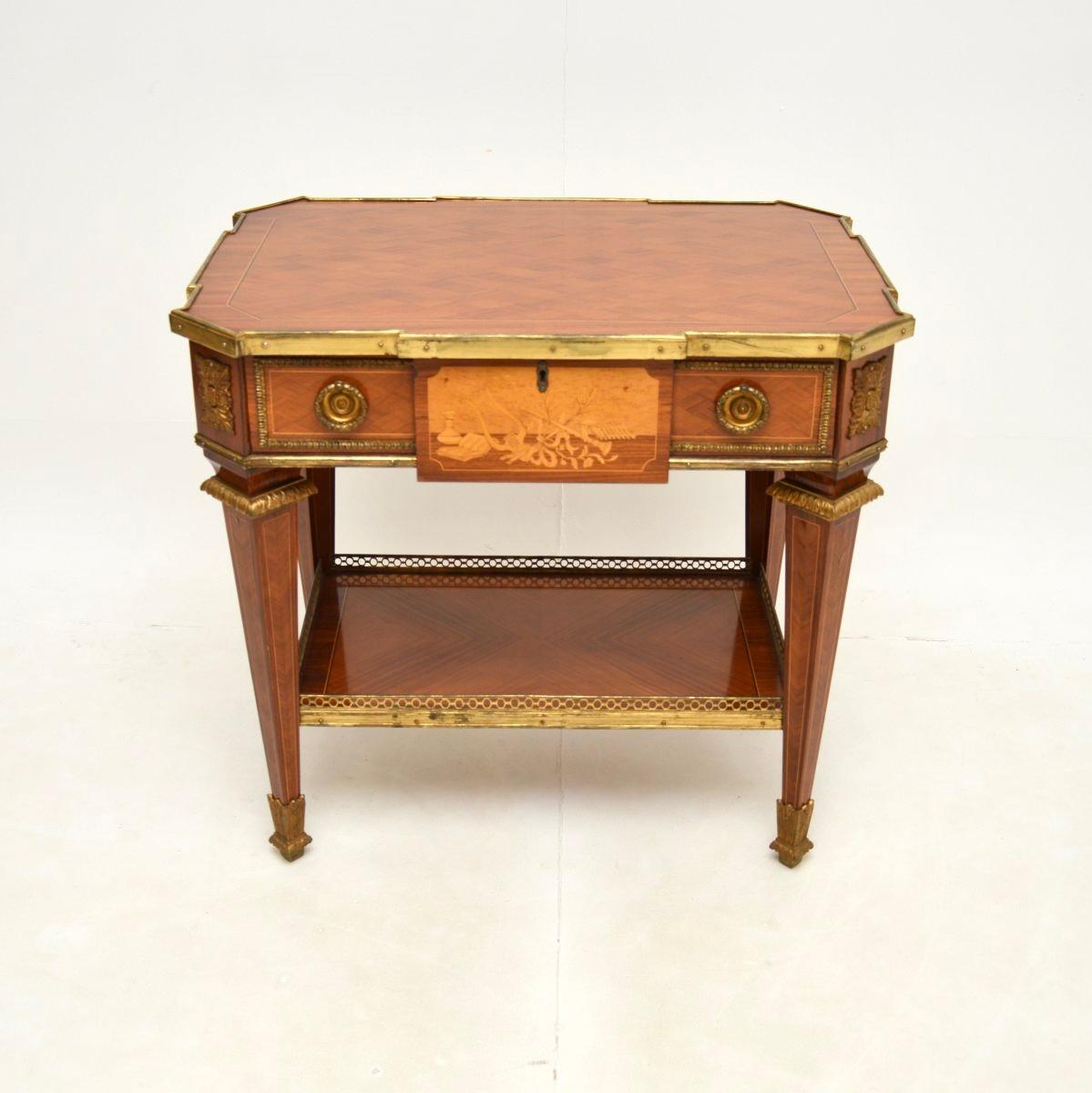 A fine and impressive antique French occasional table. This was made in France, it dates from around the 1930’s.

The quality is outstanding, this has stunning inlays on the top. The back and front are finished identically with a dummy drawer on the