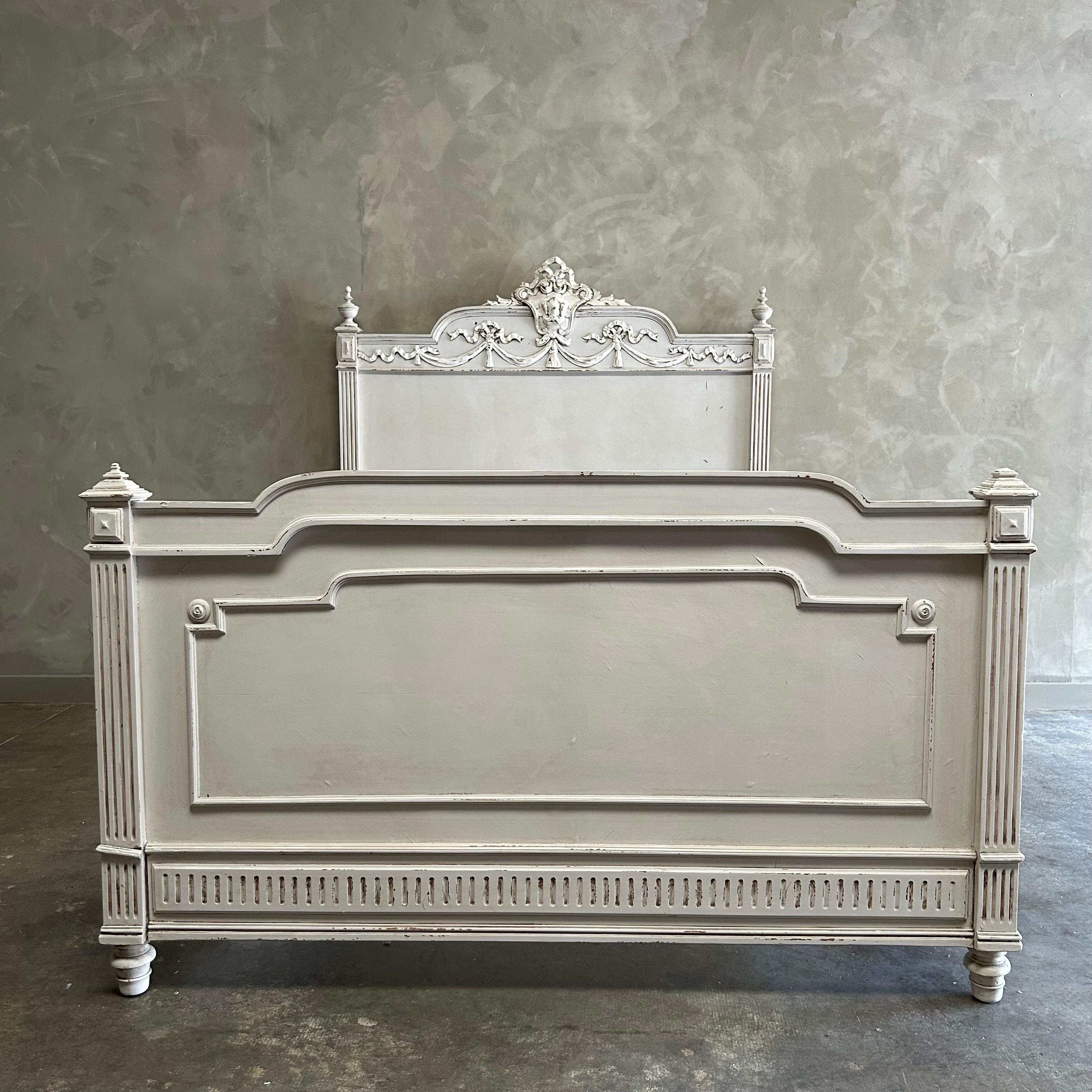 Antique French Louis XVI Style Painted Bed
Total dimensions:(assembled) 55”w x 78”d x 58”h
Footboard Height: 32”h
Inside rail dimensions: 51”w x 74”d
Can be used with a US full size mattress.  Custom slats would need to be made so that the mattress