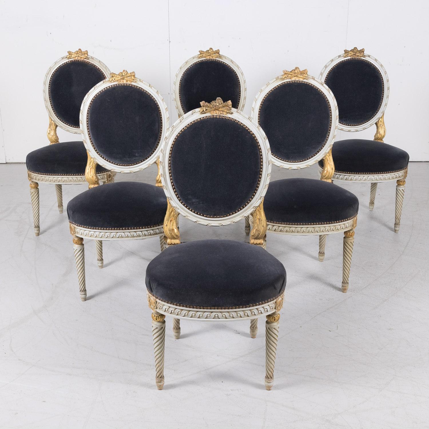 An exceptional set of six French Louis XVI style dining side chairs from Paris decorated with timeless classical styling and hand carved excellence on the entire framework, emphasizing typical neoclassical gilt carvings of acanthus leaves and laurel