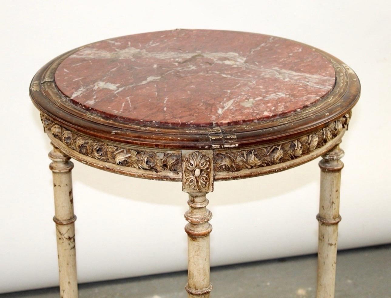 Antique French Louis XVI style round side table with marble top. Painted with Distressed Gold Gilt Accents

Gorgeous marble top with carved wooden features. 



32