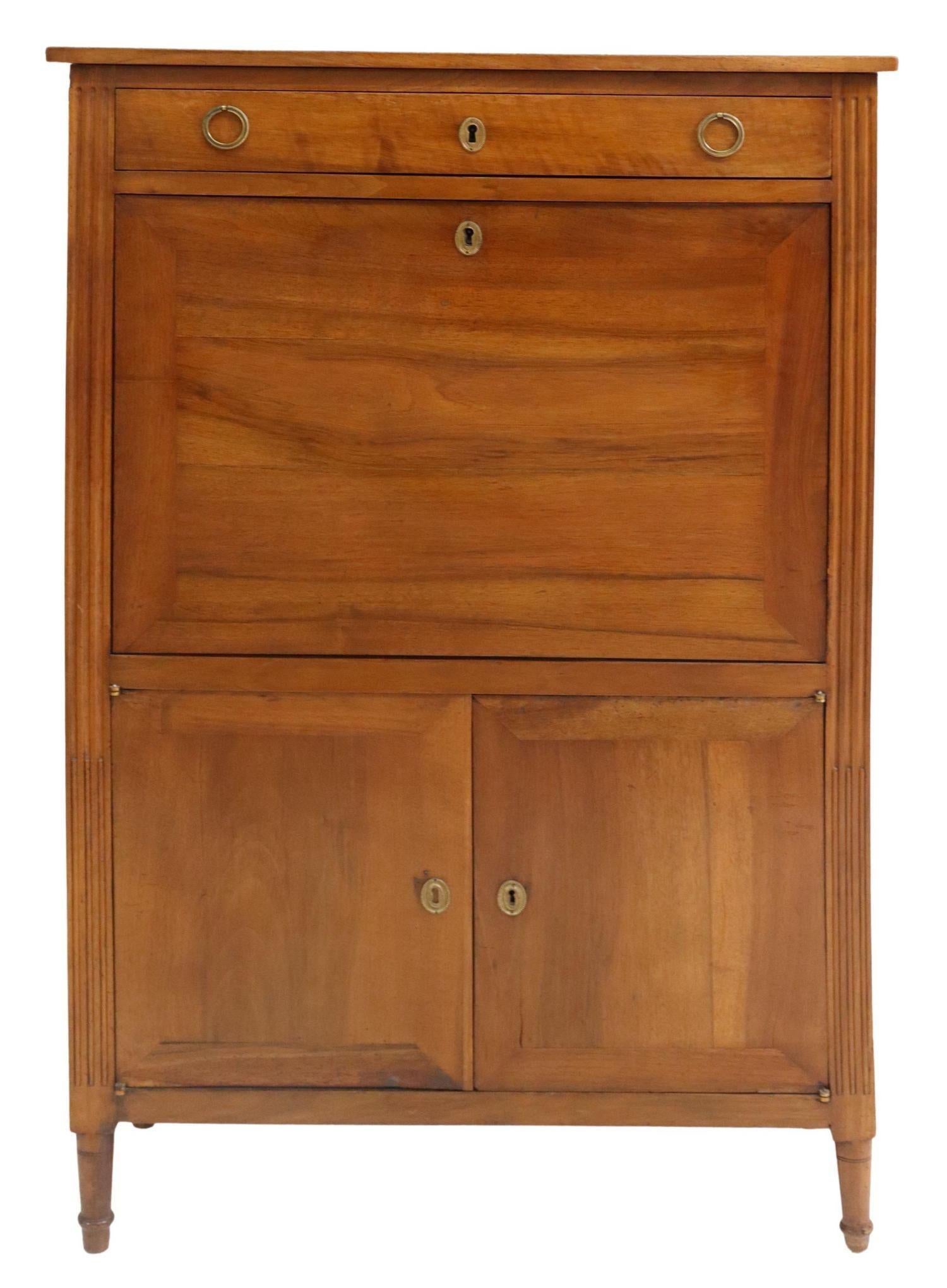 French Louis XVI style fall front desk, early 20th c. This Secretaire desk features a single drawer over fall front panel, opening to fitted interior gallery, inset leather writing surface, lower double-door cabinet opening to shelf, rising on