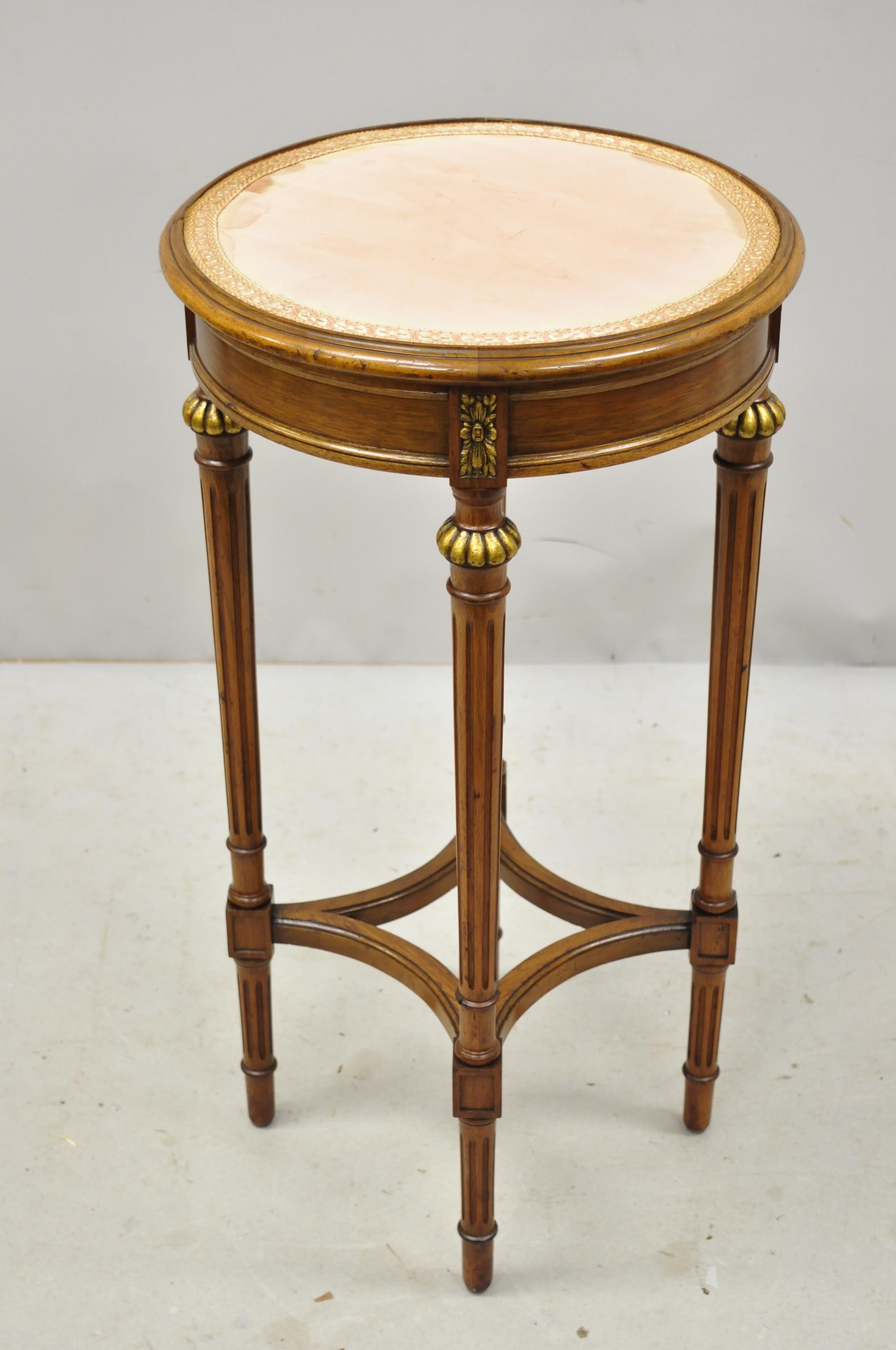 Antique French Louis XVI style small round carved walnut side lamp table. Item features solid wood frame, beautiful wood grain, nicely carved details, tapered legs, great style and form. Probably had a glass top, circa early 20th century.