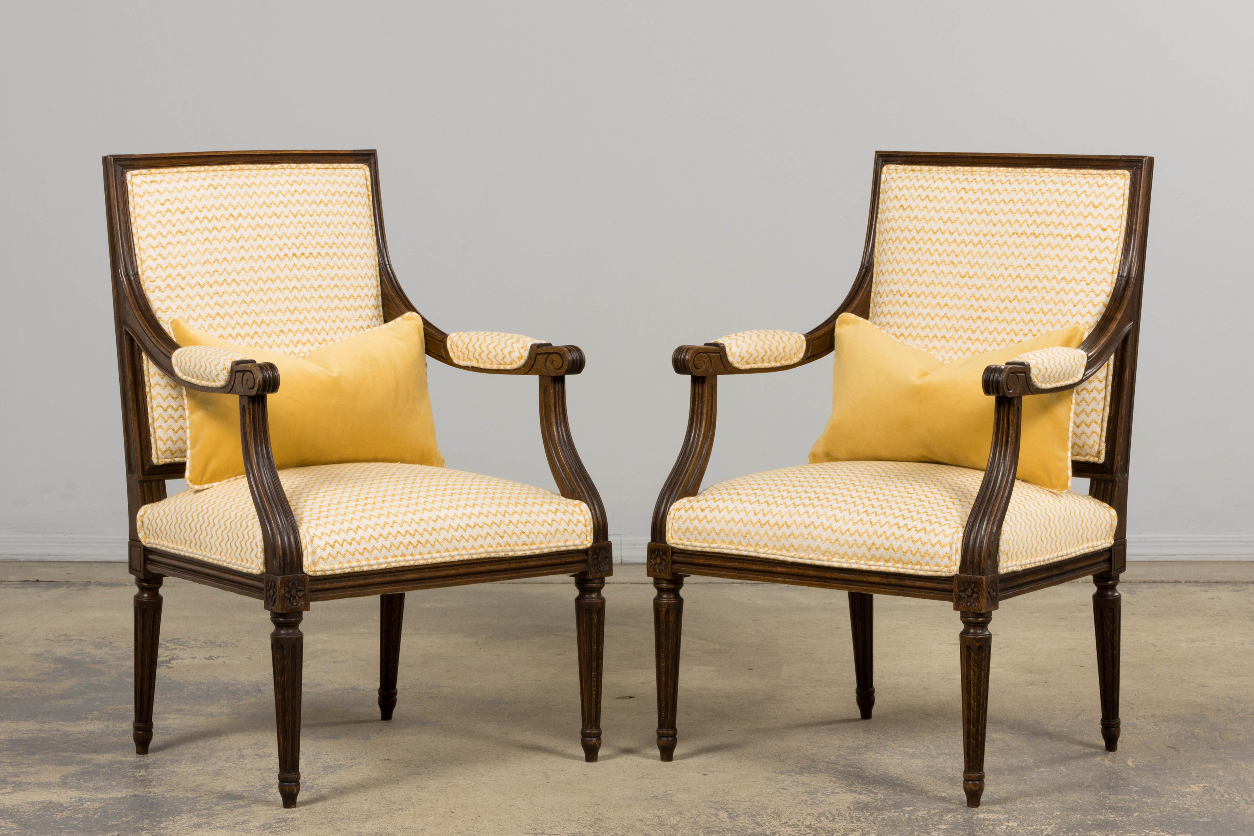 Intagliato a mano Antique French Louis XVI Style Walnut Armchairs in Yellow Linen - A Pair in vendita