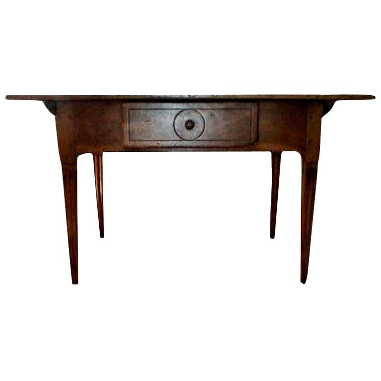 Antique French Louis XVI style walnut Cobbler's work table.
Handsome 19th century French Louis XVI walnut work table or cobbler's table with fluted legs and a single drawer. This versatile French table could be used as a side table, kitchen work