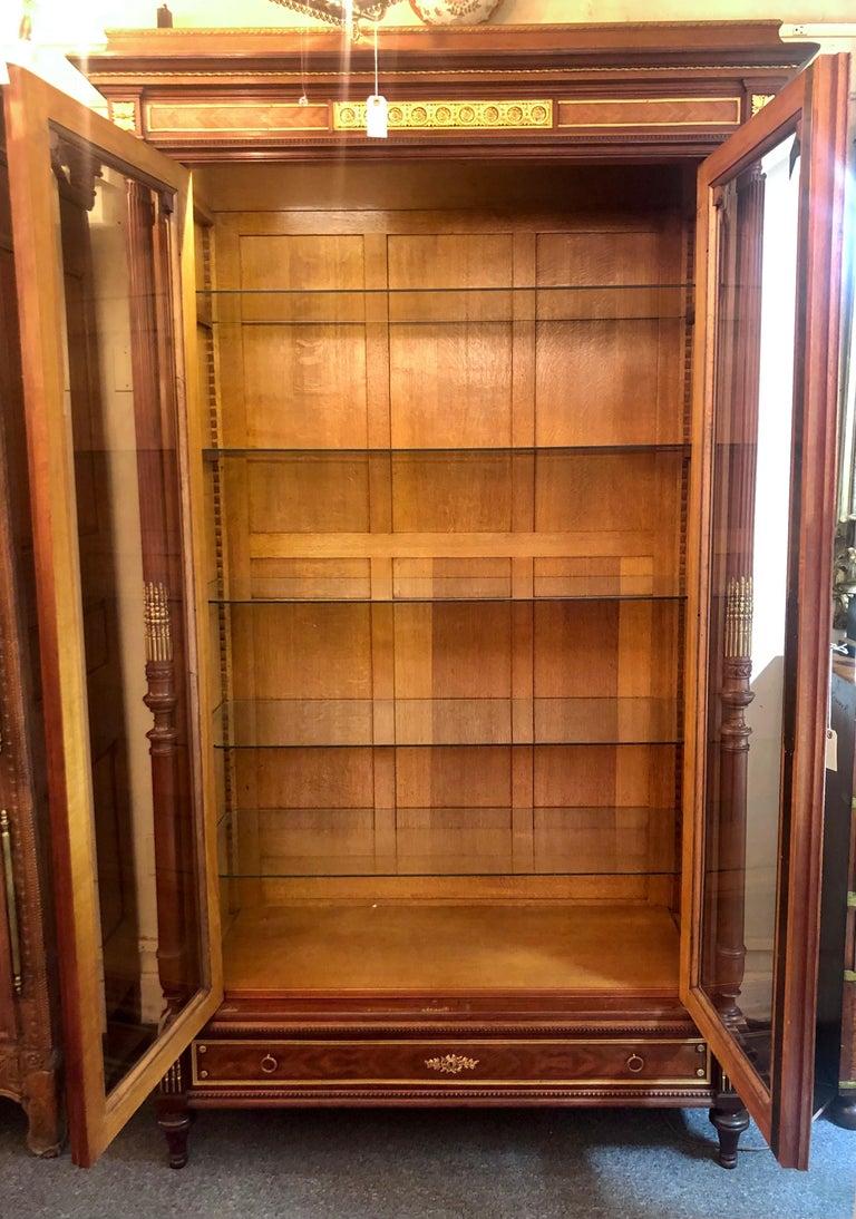 Antique French Louis XVI style two door beveled glass display cabinet with interior glass shelves, Circa 1870-1880.