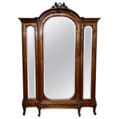 Antique French Louis XVI Walnut 3 Door Armoire with Beveled Mirrors, Circa 1890.