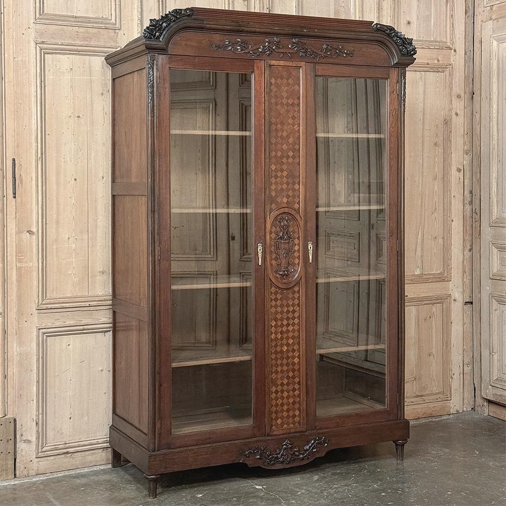 Antique French Louis XVI Walnut Bookcase ~ Display Armoire is a majestic example of the neoclassical revival that captivated the attentions of Louis XVI and his Queen Marie Antoinette.  Crafted from fine French walnut, it features a rectilinear