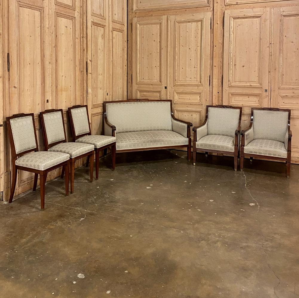 Antique French Louis XVI walnut canape was created with timeless neoclassical style! The tailored framework is accented by a subtly arched seat back centered with a wreath, ribbon and laurel swag motif in bas relief. The armrests curve away from the