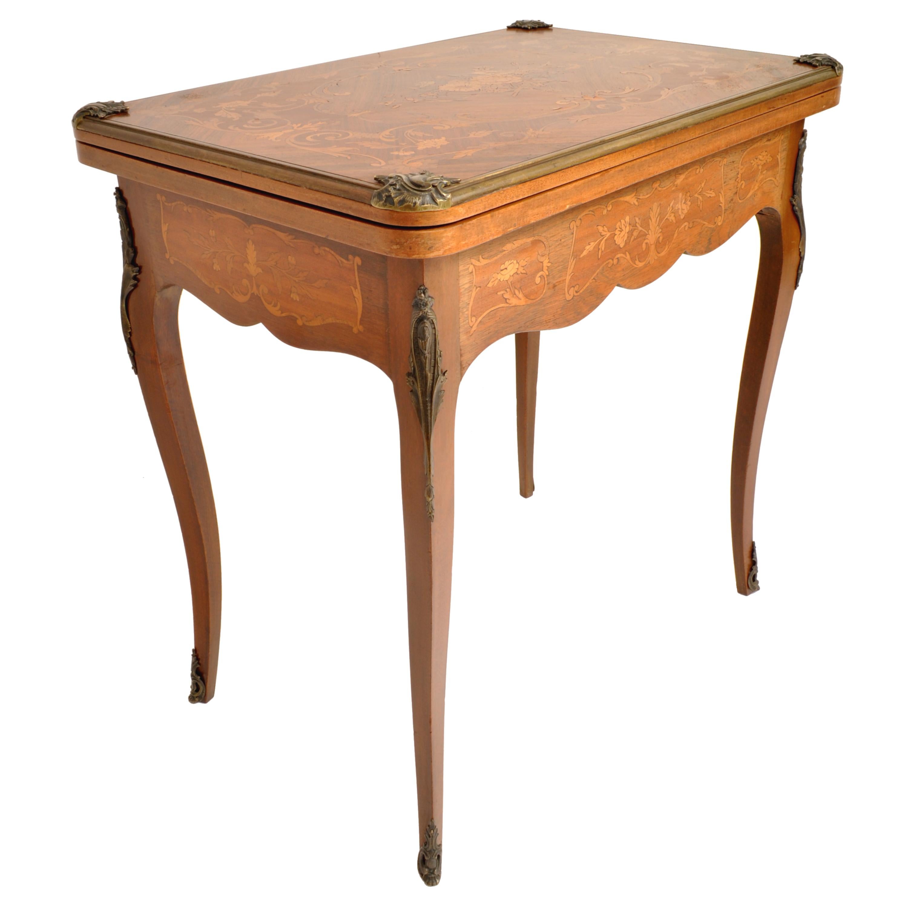 A fine & elegant antique French Louis XVI walnut/fruitwood inlaid card/games table, circa 1880.
The table having a feather banded walnut top, finely inlaid with a central floral panel & surrounded by inlaid foliate, at each corner there is a
