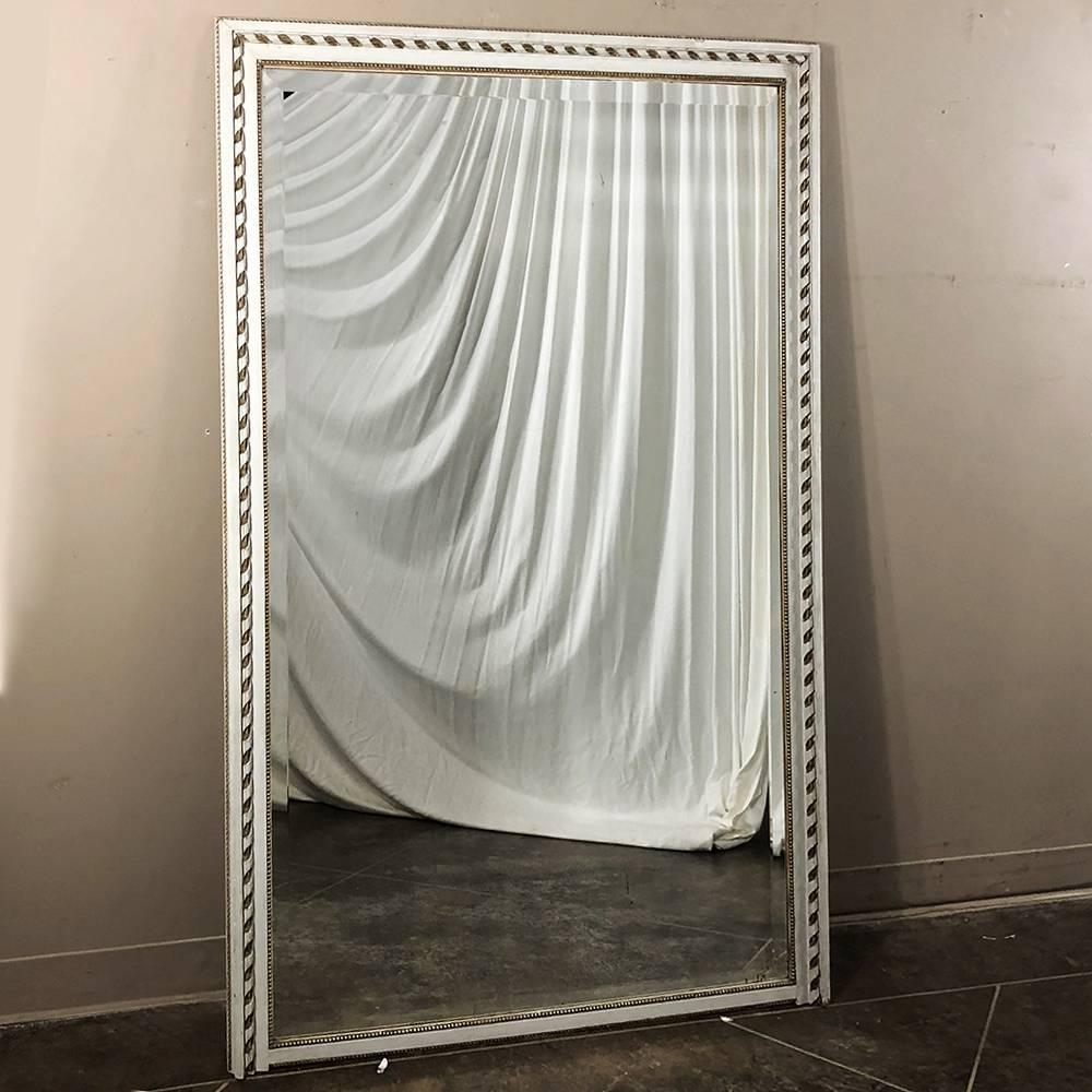 Antique neoclassical French Louis XVI white painted bevelled mirror is ideal for the tailored, uncluttered look, while still providing a Classic style statement only enhanced by the carved detail, distressed painted finish and original bevelled