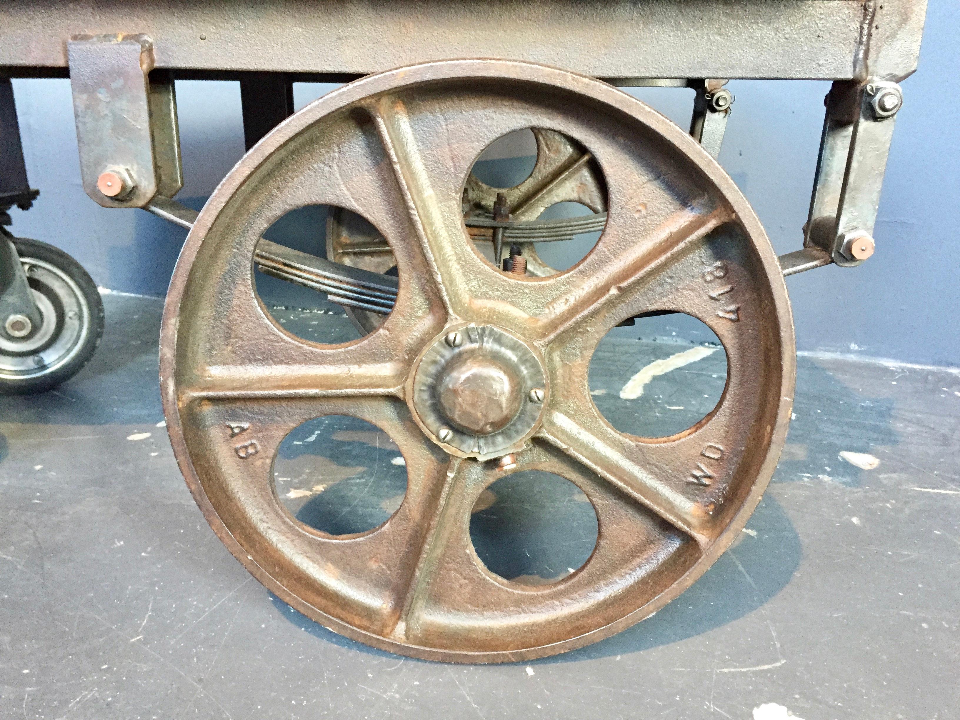 Antique French luggage trolley coffee table in cast iron and with the original oak
Originally used for luggage at a train station.
Beautiful cast iron wheels with leaf spring suspension.
Great patina to the iron and oak.

 