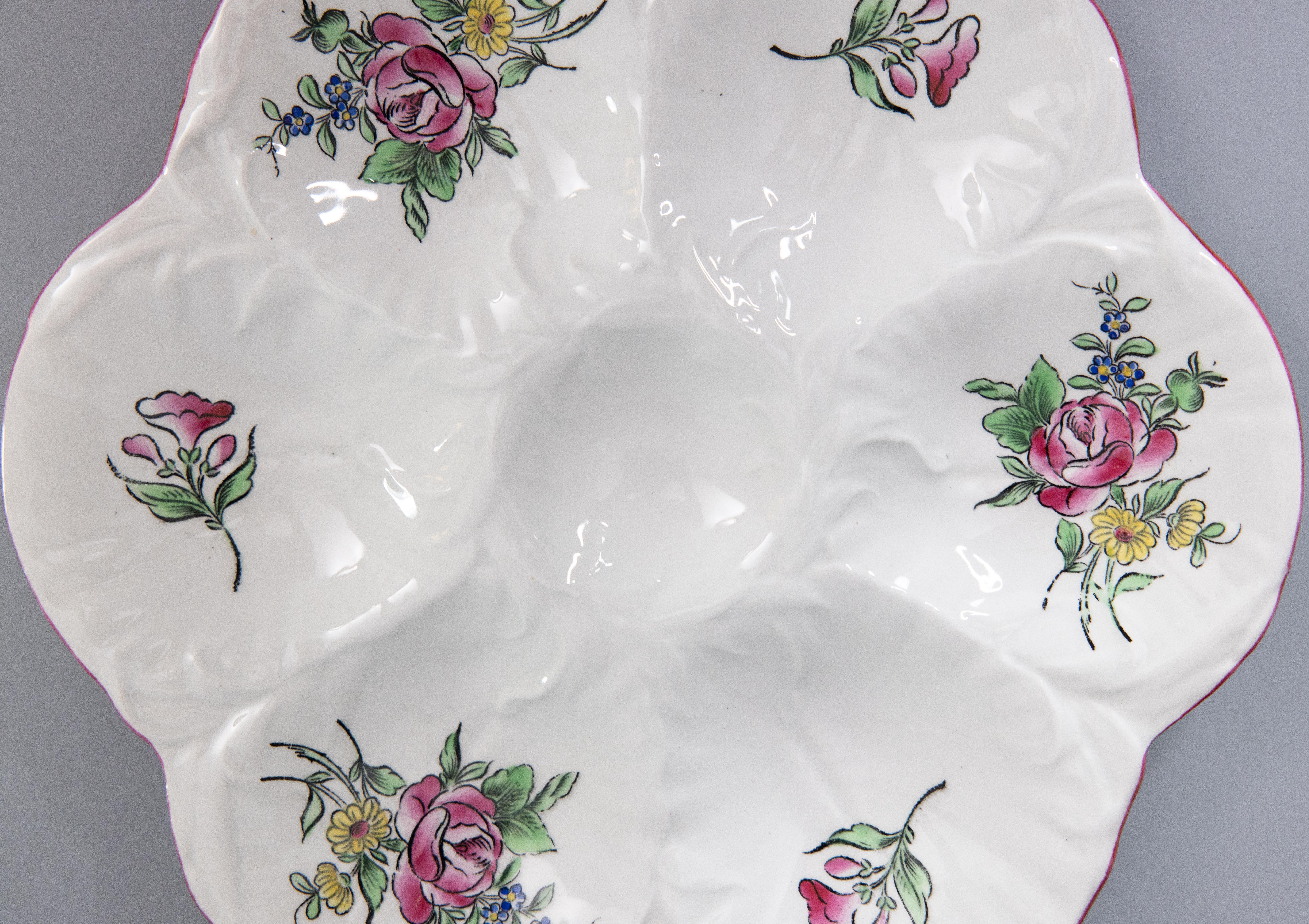 A gorgeous antique French Majolica floral porcelain oyster plate by Keller & Guérin made in Luneville, France, circa 1900. Maker's mark on the reverse. This fine quality oyster plate is hand painted in the Old Strasbourg porcelain pattern with