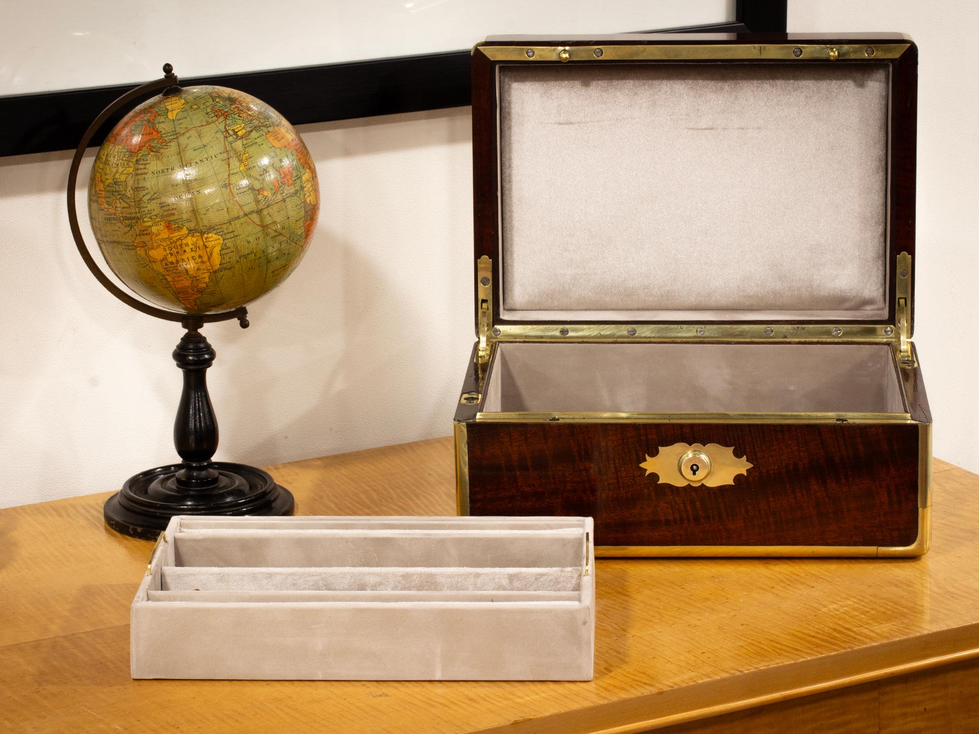 Circa 1830

From our Jewellery Box collection, we are pleased to offer this Antique Mahogany Jewellery Watch Box. The Antique Box of slender rectangular form made from solid Mahogany with brass edging having a central rectangular vacant initial