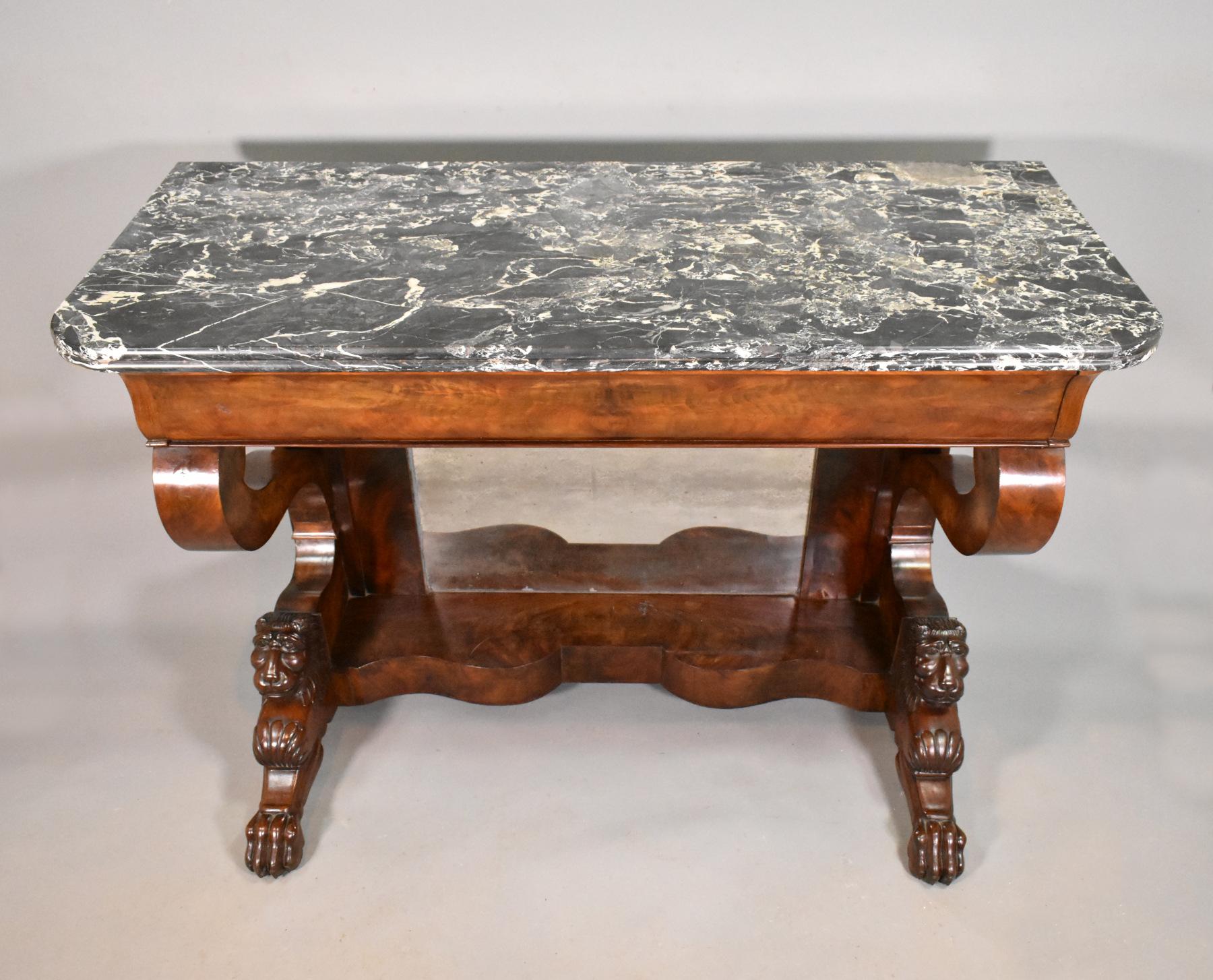 Antique French mahogany console table Louis Philippe.

This impressive console table features a variegated black, white and grey Brèche marble top with a moulded outer edge. 

Below this is full-width drawer concealed within the frieze. The