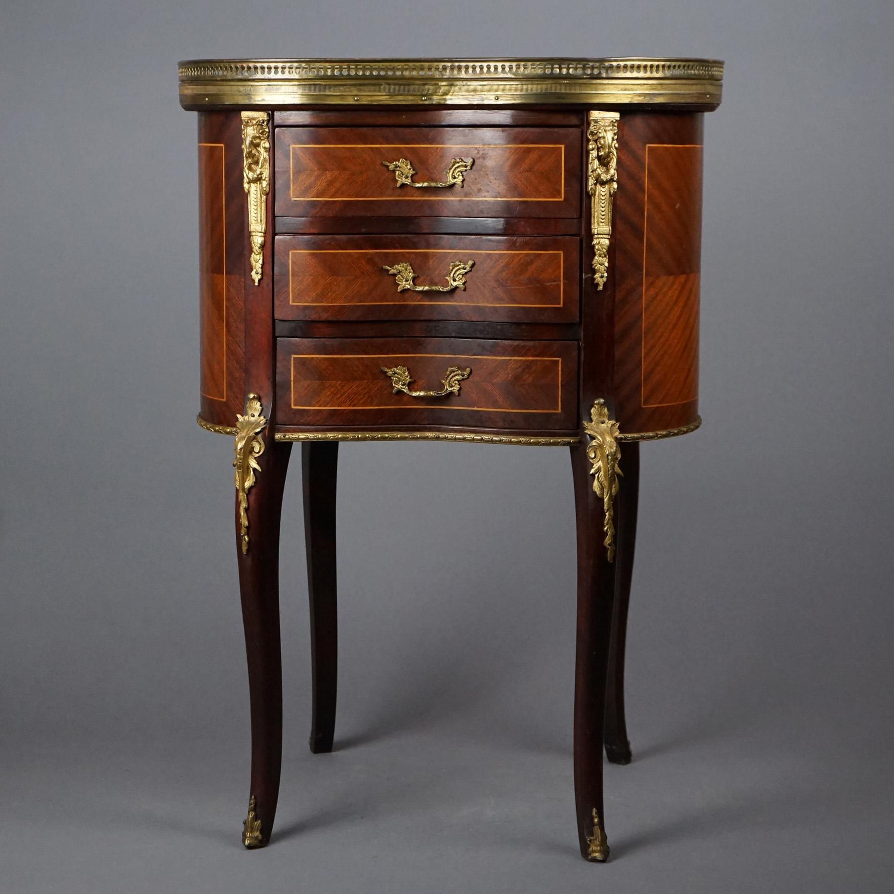 An antique Louis XVI style French side stand offers marble top with pierced gallery over mahogany case in kidney form and having three drawers with kingwood inlaid panels, raised on cabriole legs, cast ormolu mounts throughout, c1900

Measures -