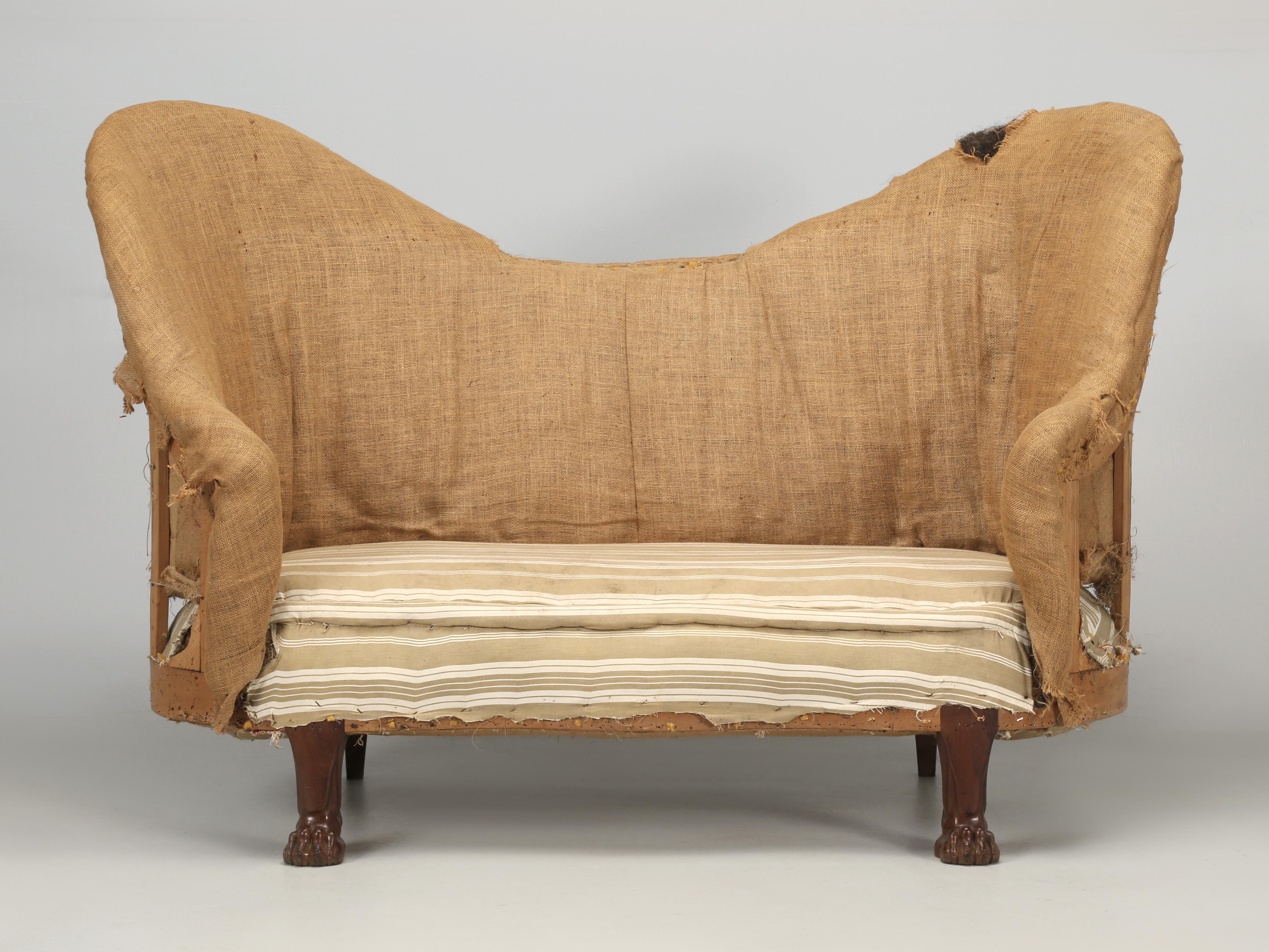 Antique French settee or loveseat deconstructed and probably made in the late 1800's. When you take a hard look at the lion paw feet, you'll notice two things, the wood is a very high grade mahogany and the carving quality is excellent. Great for